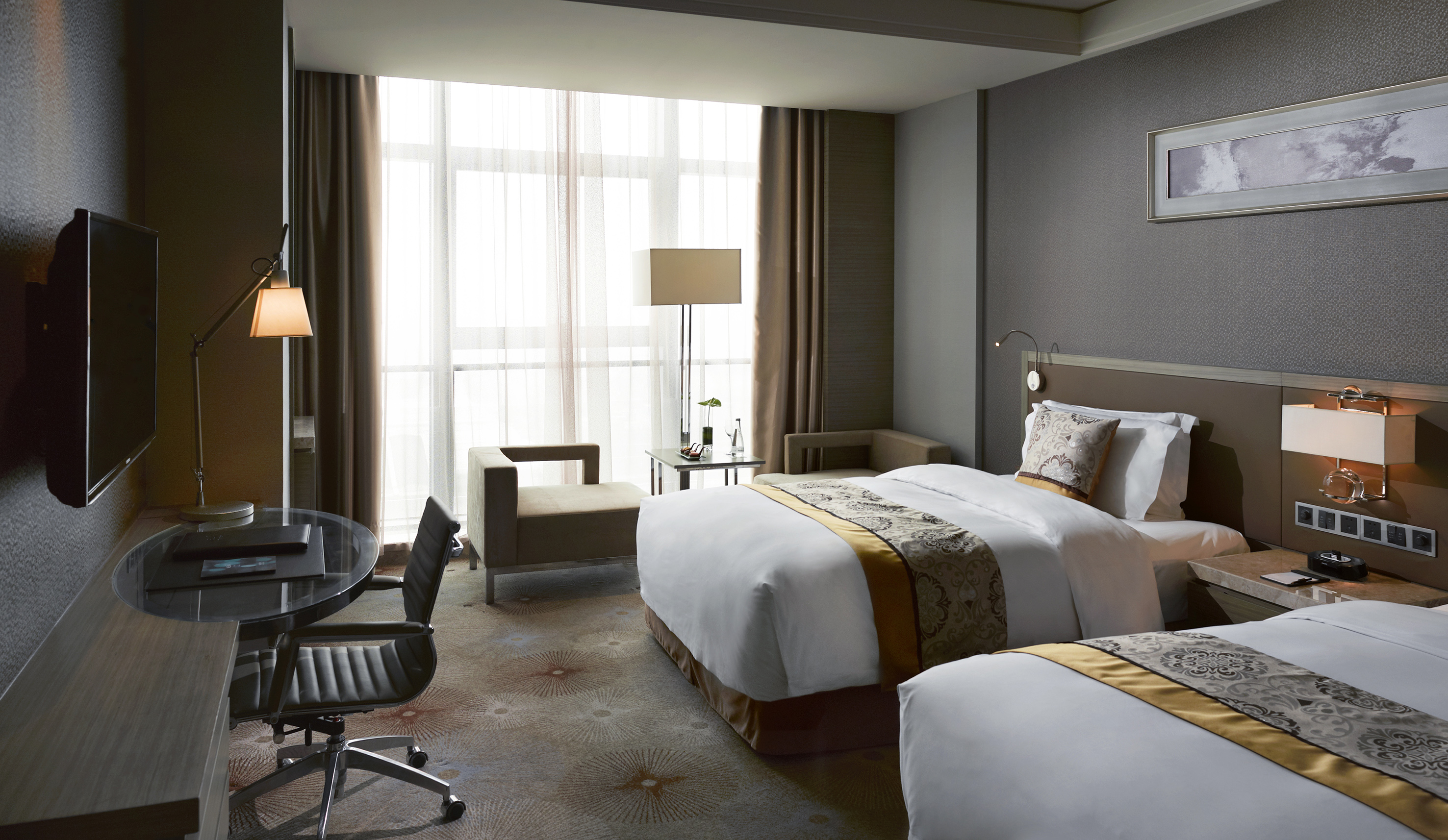 Elegant hotel room with twin beds, desk, TV, and large window with curtains.