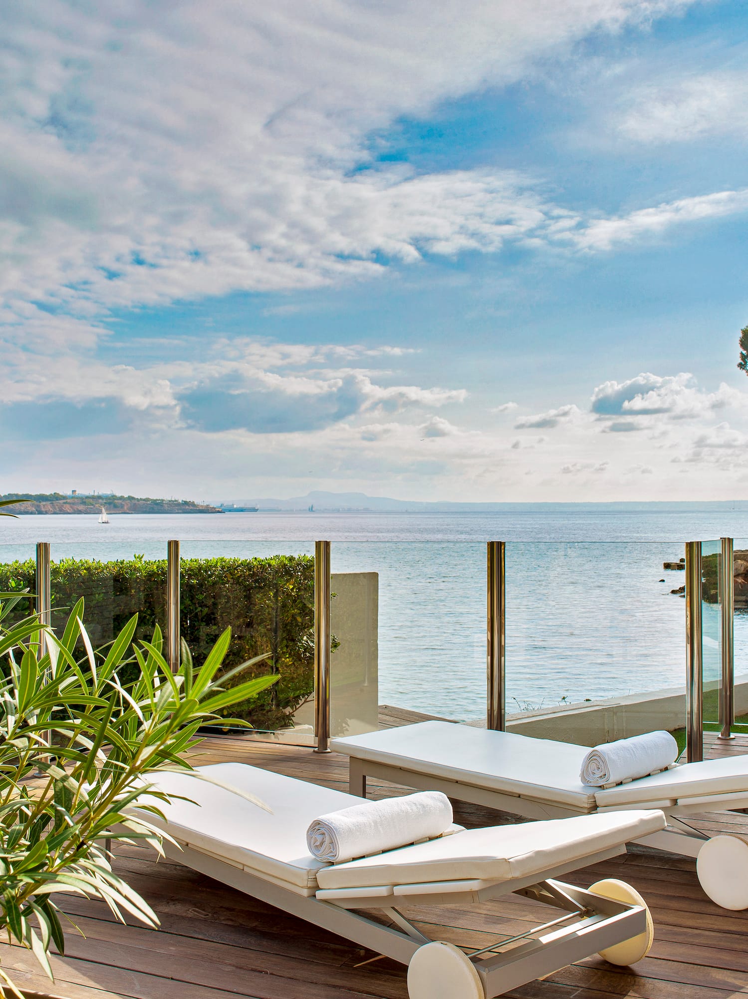 a deck with chairs and plants on it