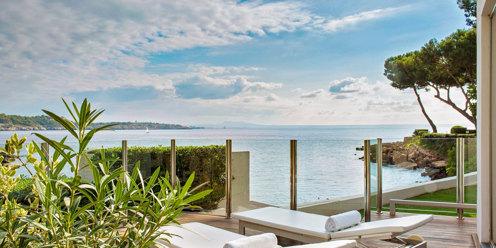 a deck with chairs and plants on it