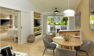 a living room with a table and chairs