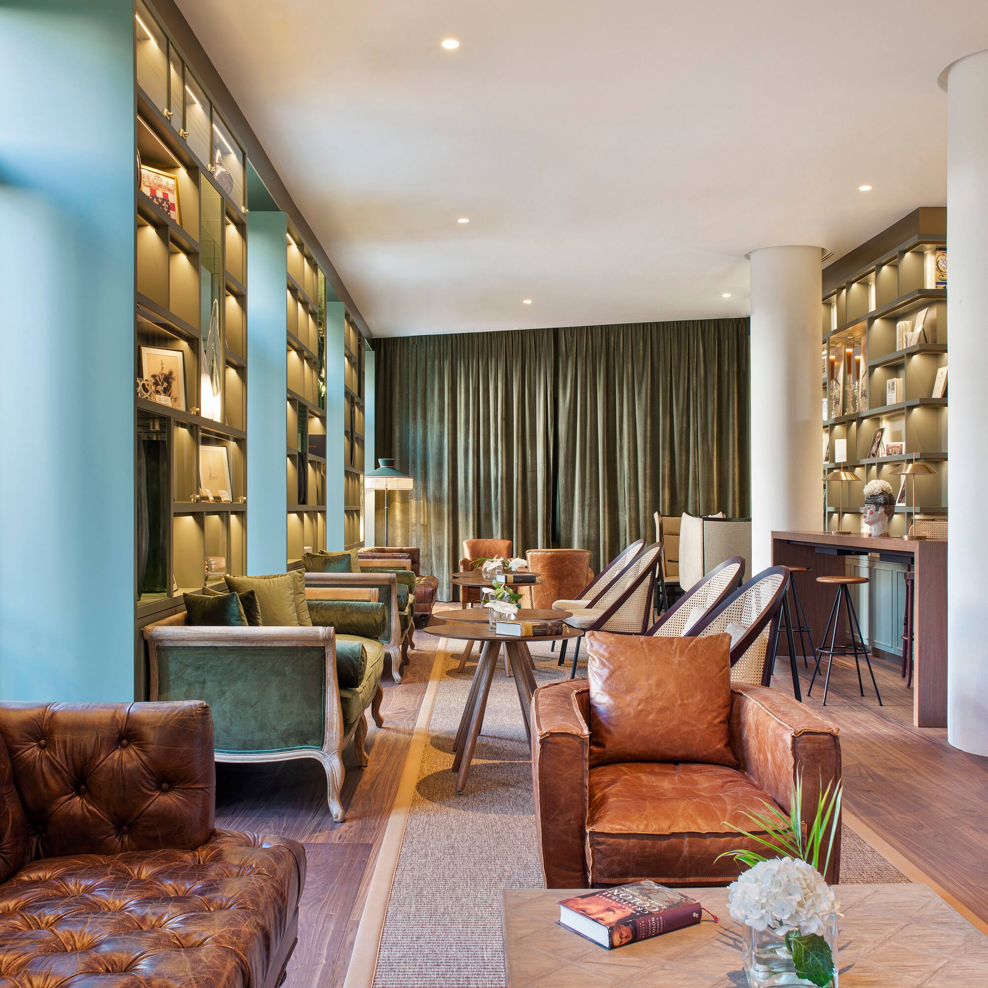 a room with a couch and chairs