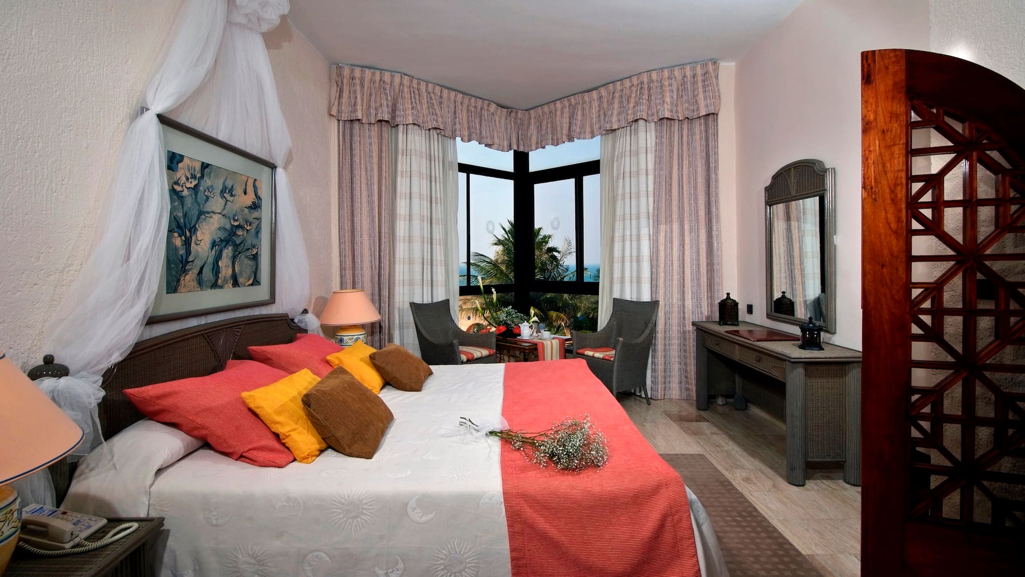 a bedroom with a bed and a table and chairs