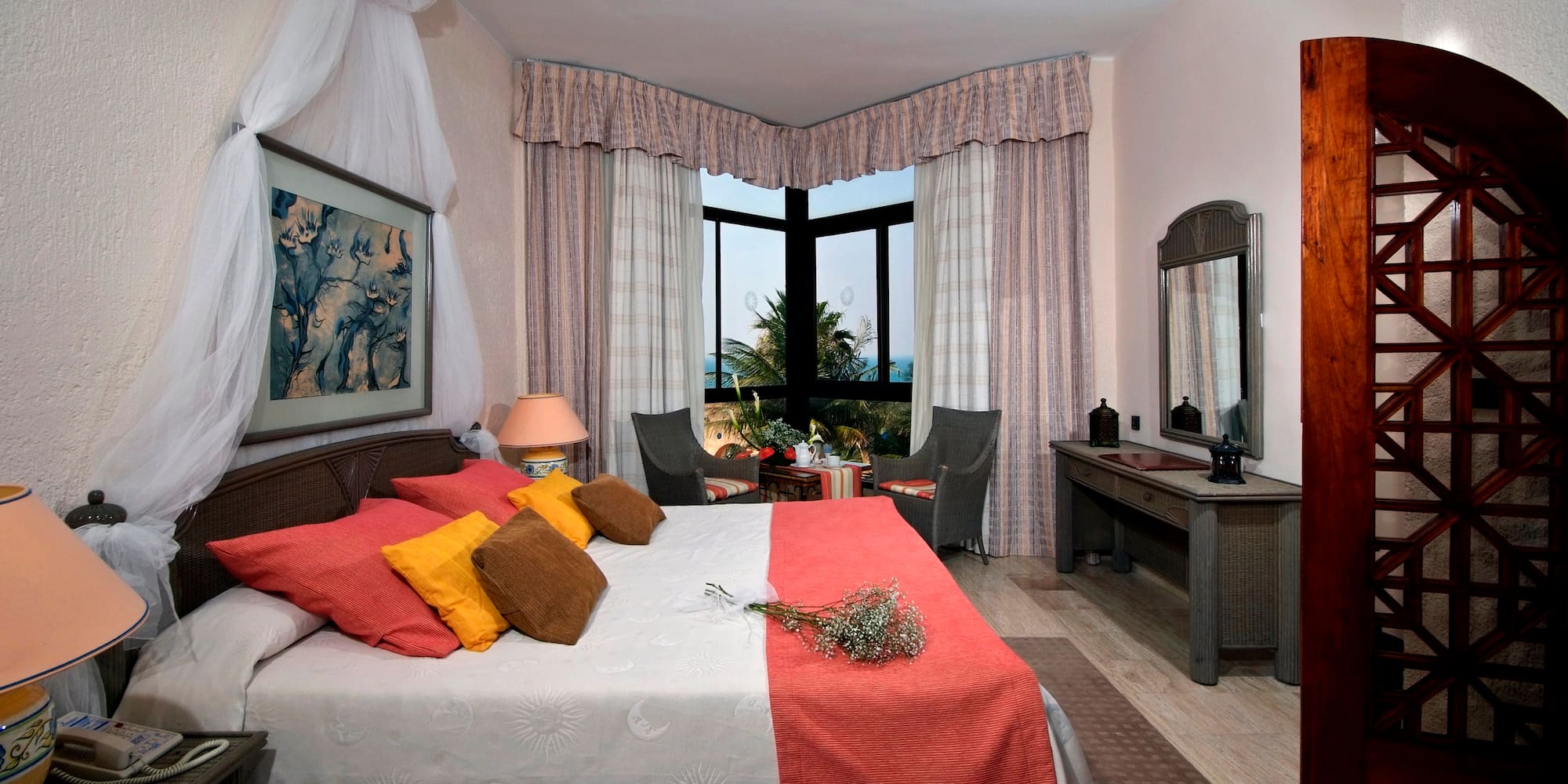 a bedroom with a bed and a table and chairs