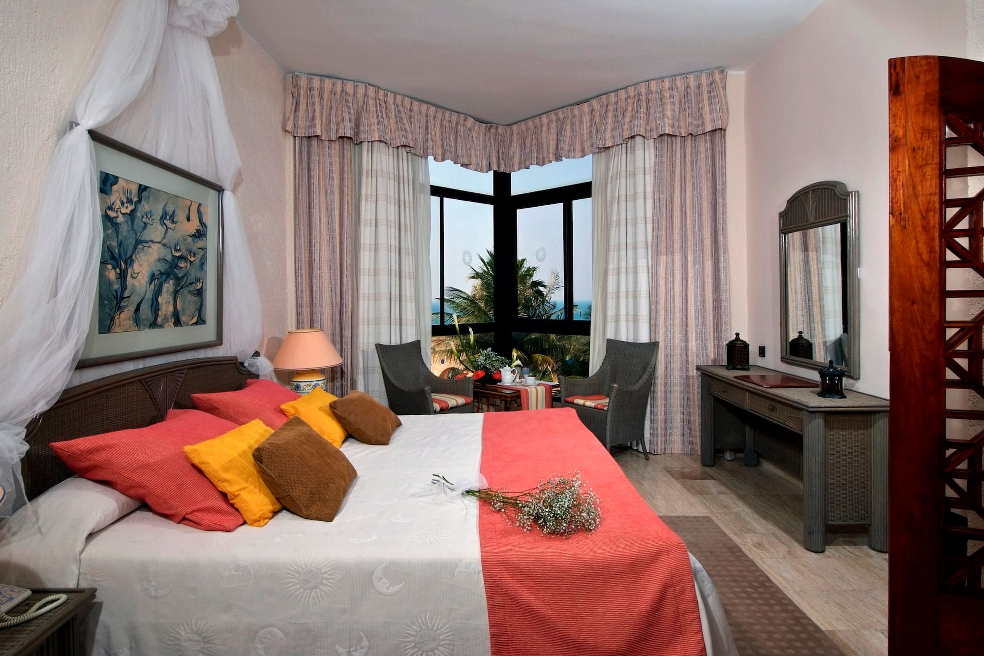 a bedroom with a bed and a table and chairs