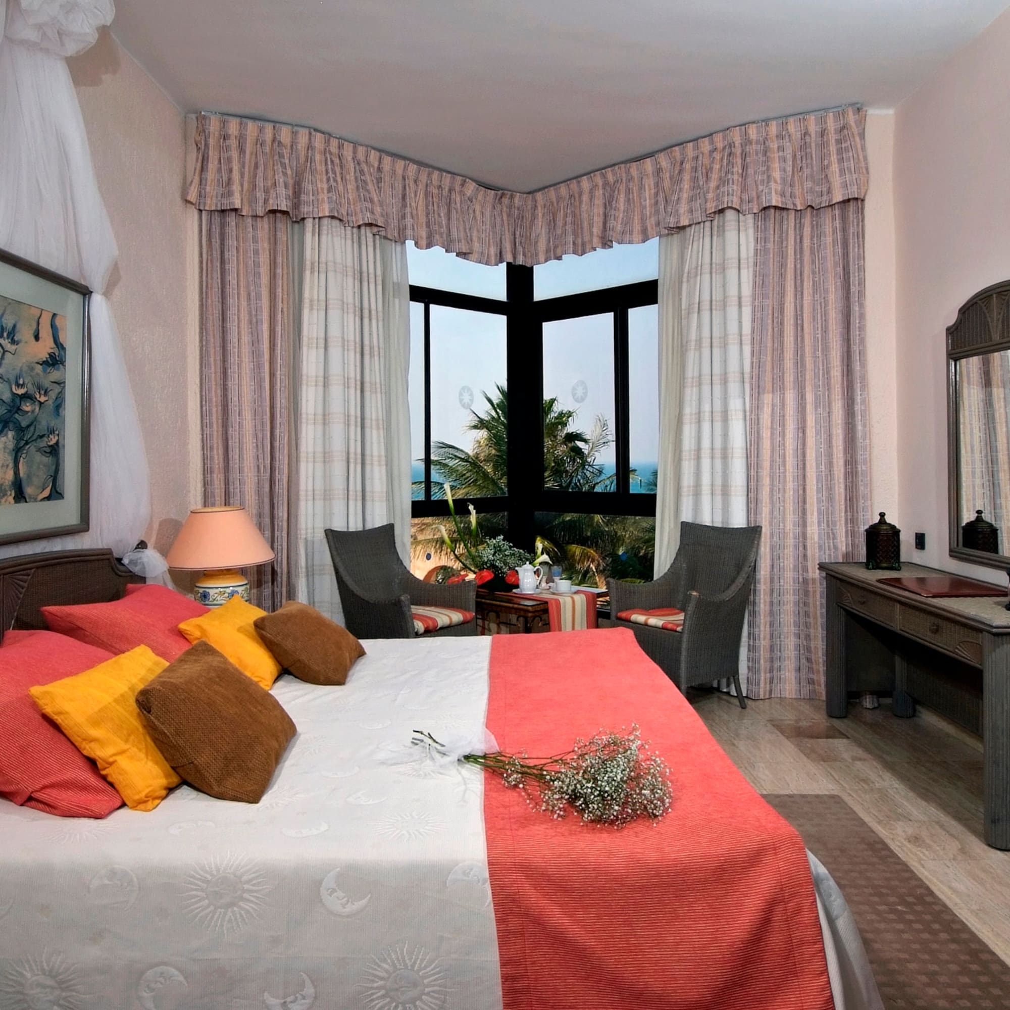 a bedroom with a bed and a table and chairs