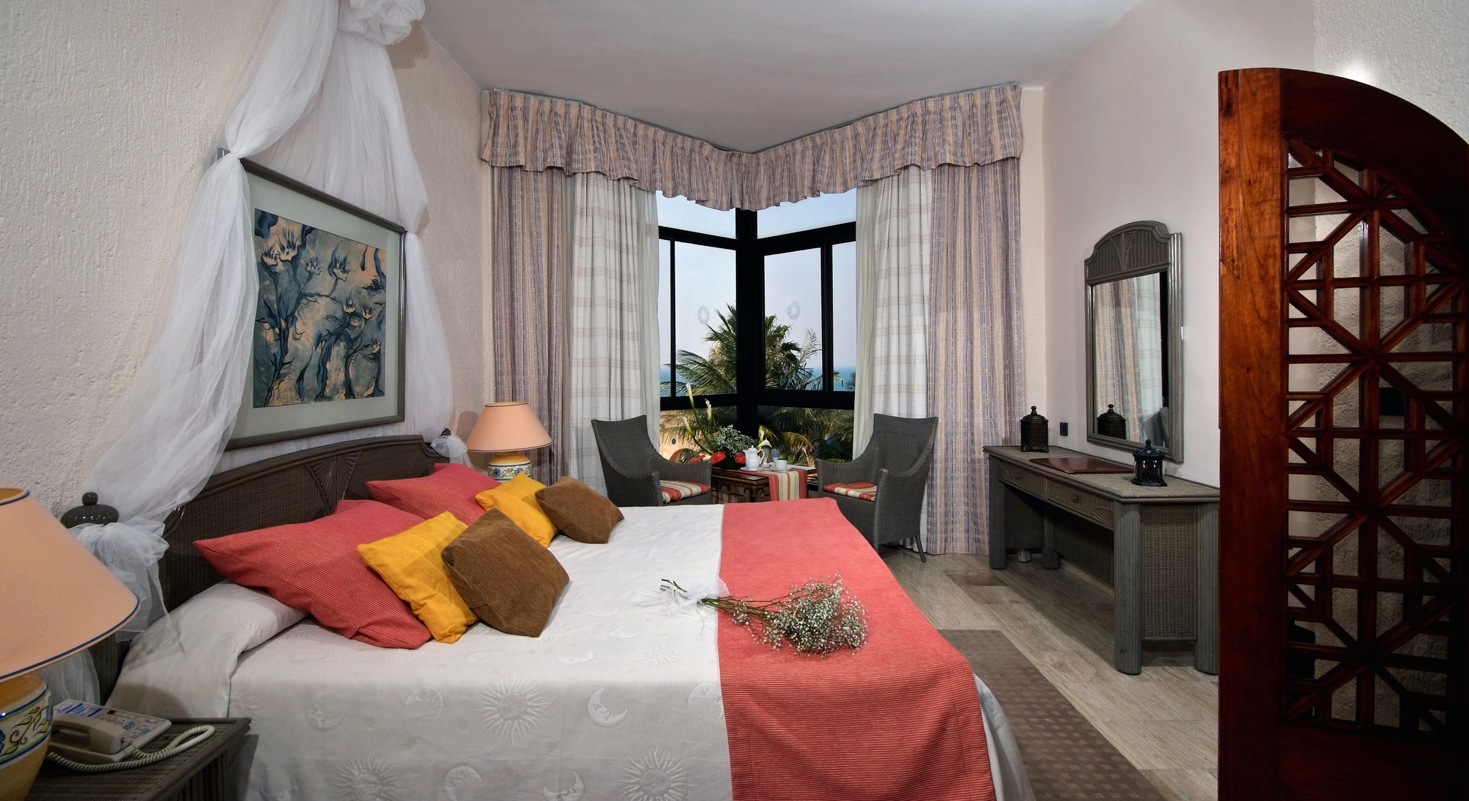 a bedroom with a bed and a table and chairs