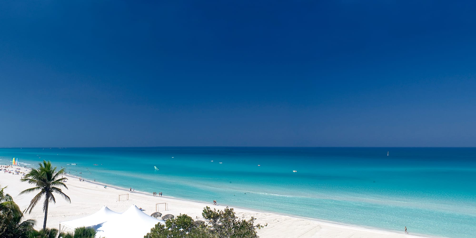 a beach with white sand and blue water