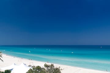 a beach with white sand and blue water