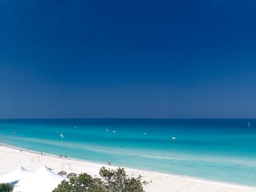 a beach with white sand and blue water