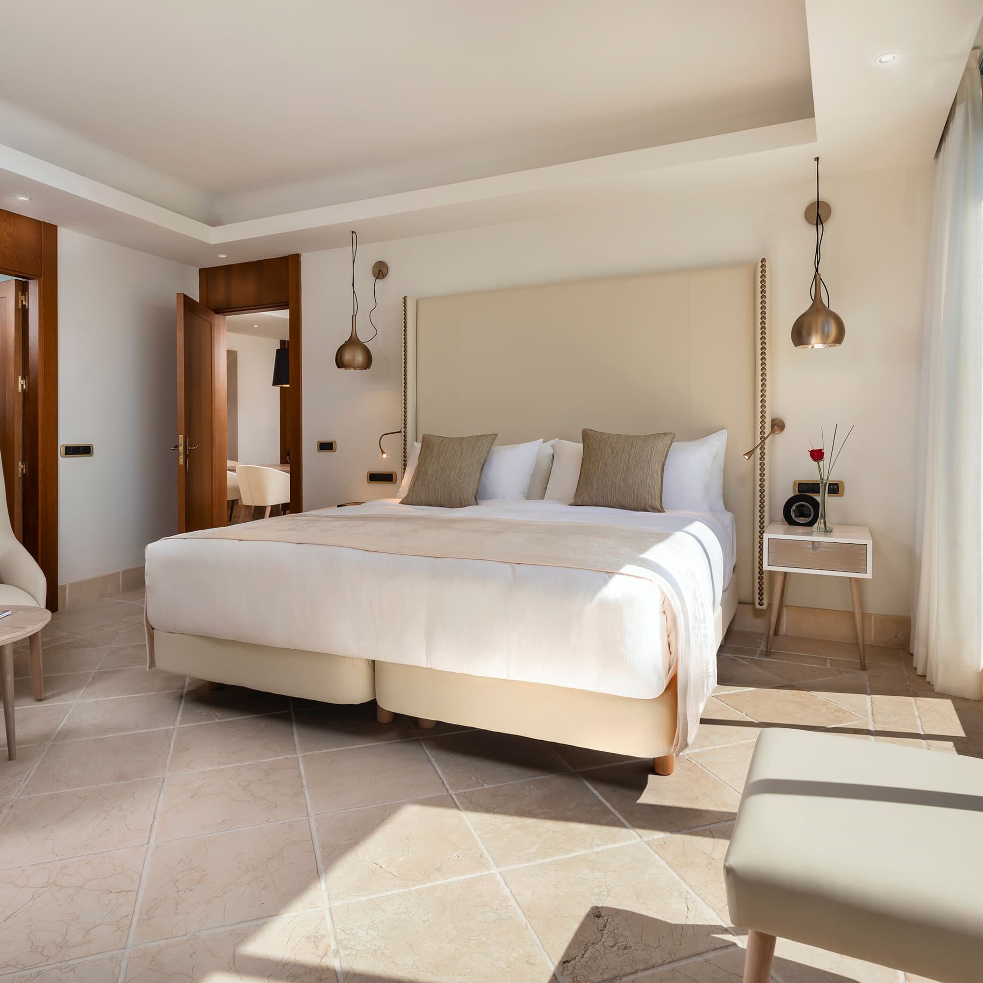 a bedroom with a bed and chairs