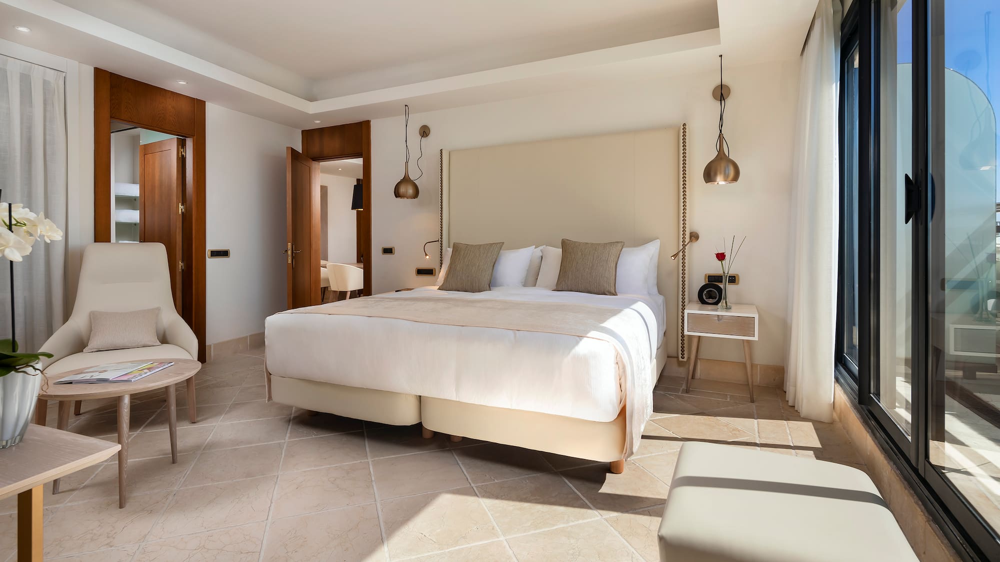 a bedroom with a bed and chairs