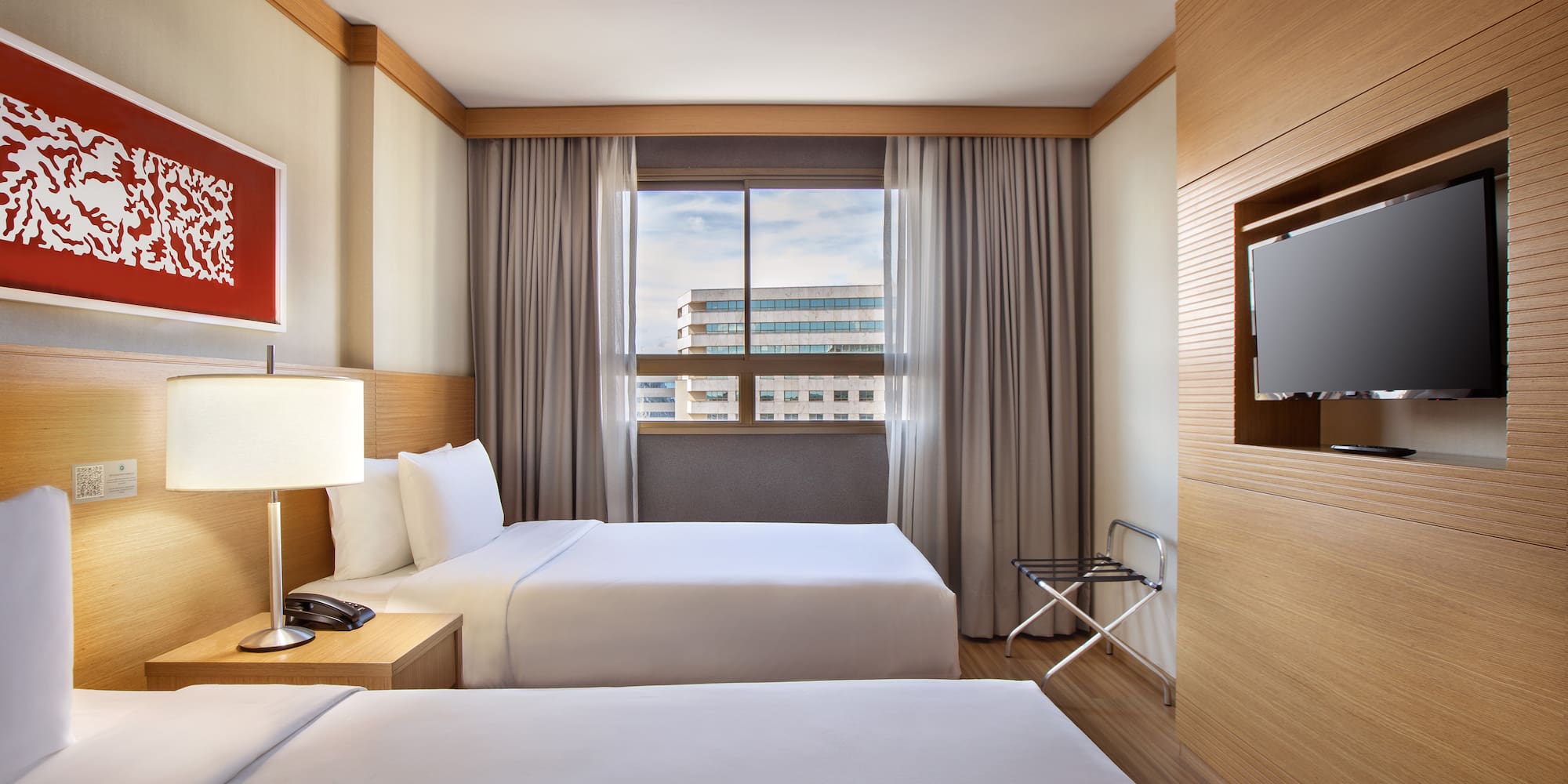 a room with two beds and a tv