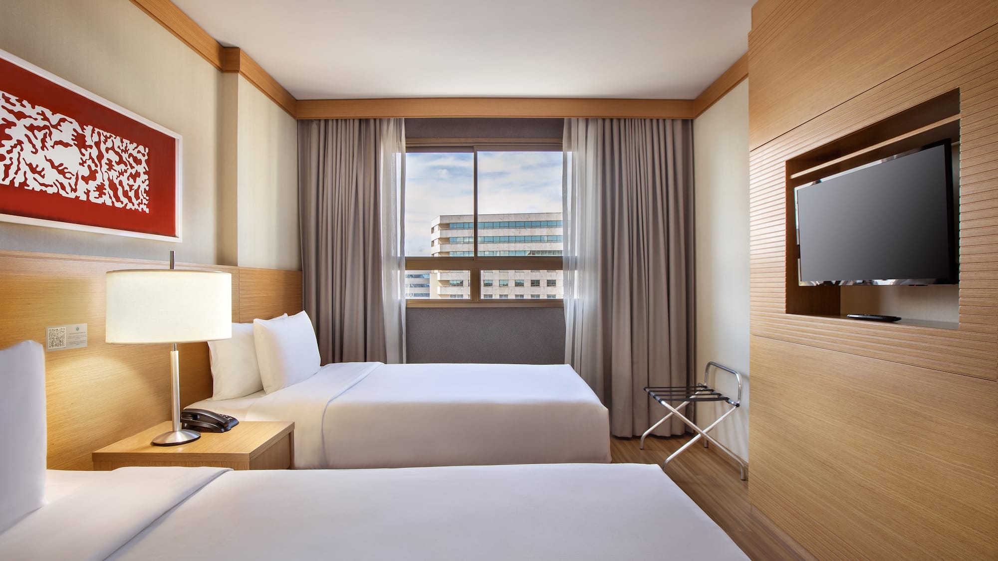 a room with two beds and a tv