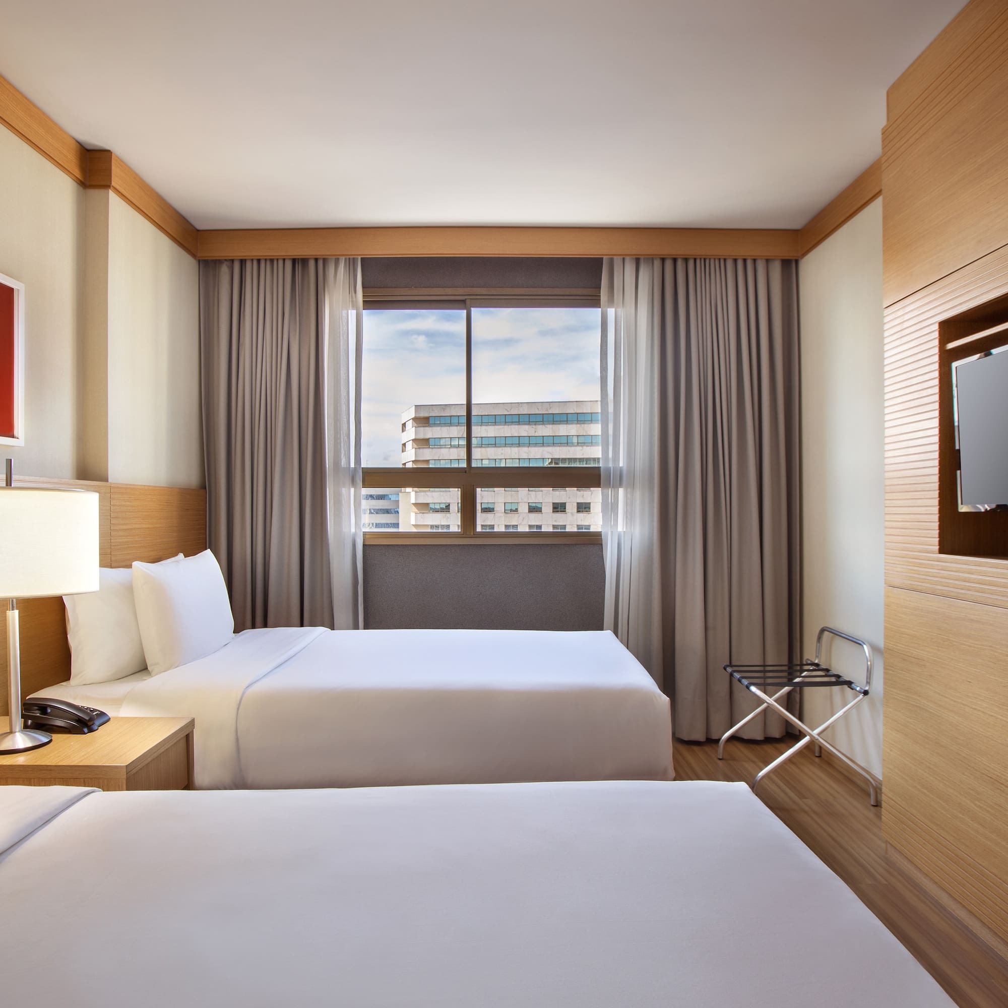 a room with two beds and a tv