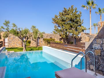 a pool with trees and a stone wall
