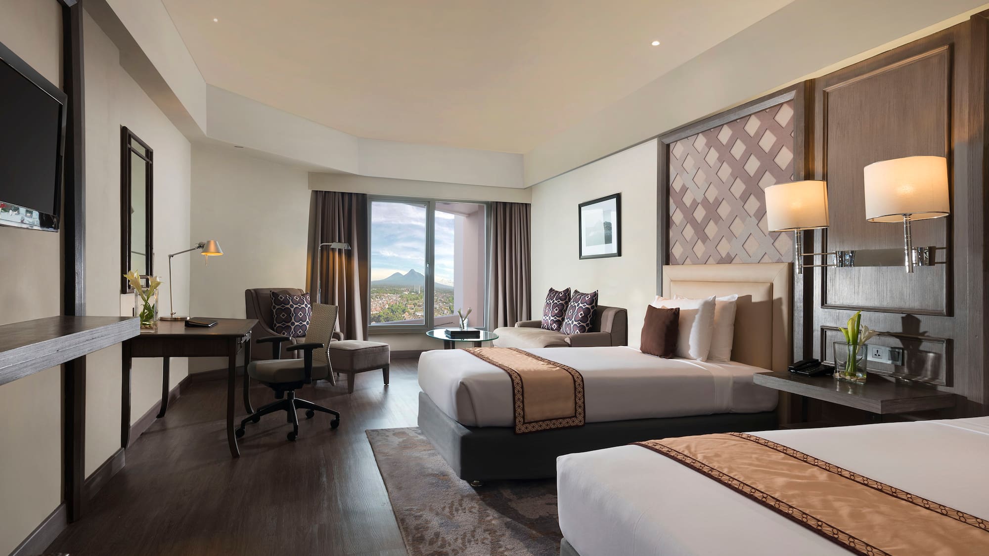 a room with two beds and a desk