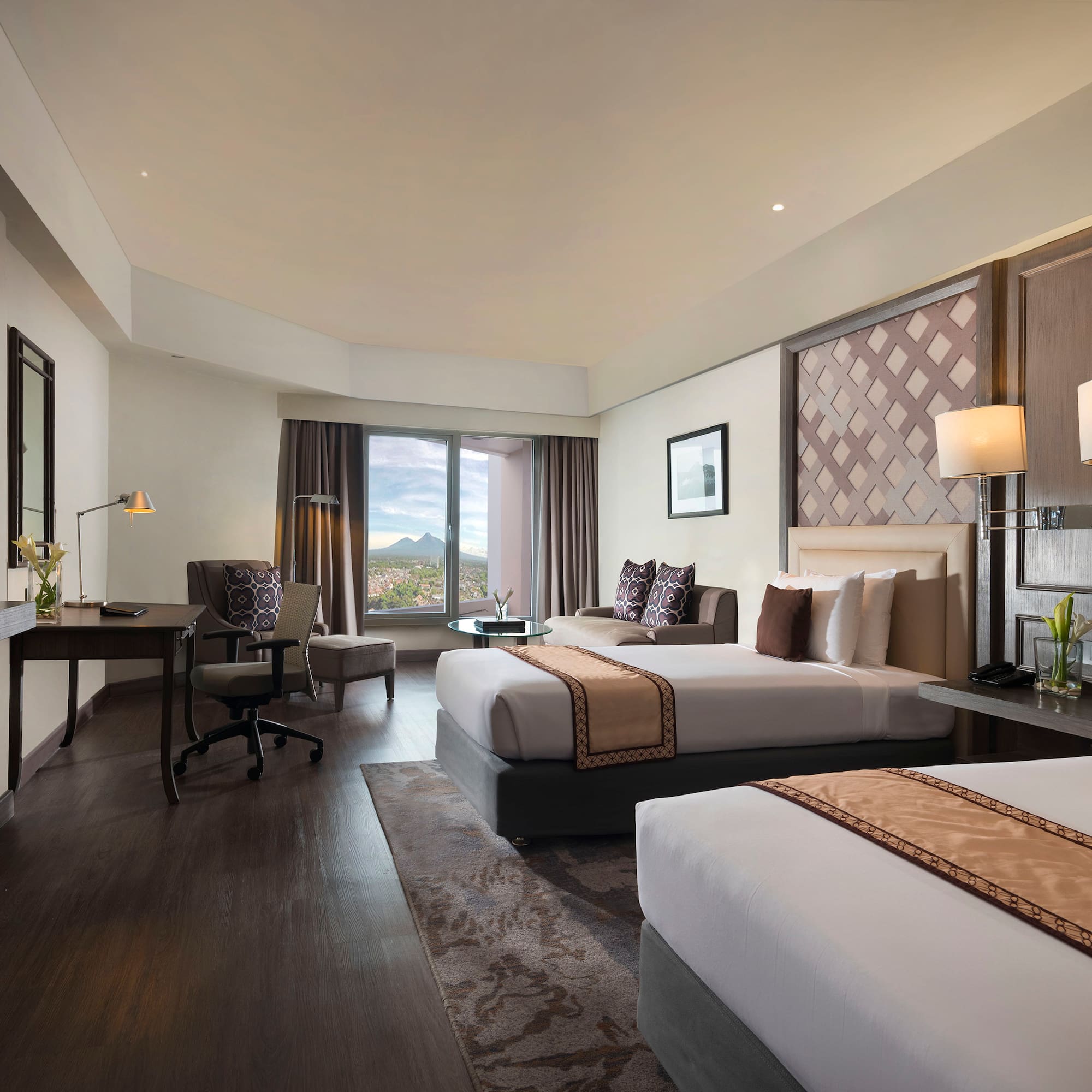 a room with two beds and a desk