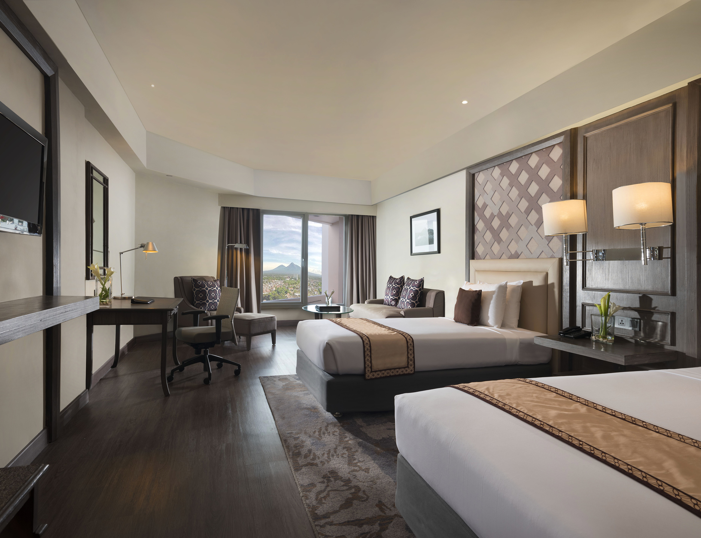 a room with two beds and a desk