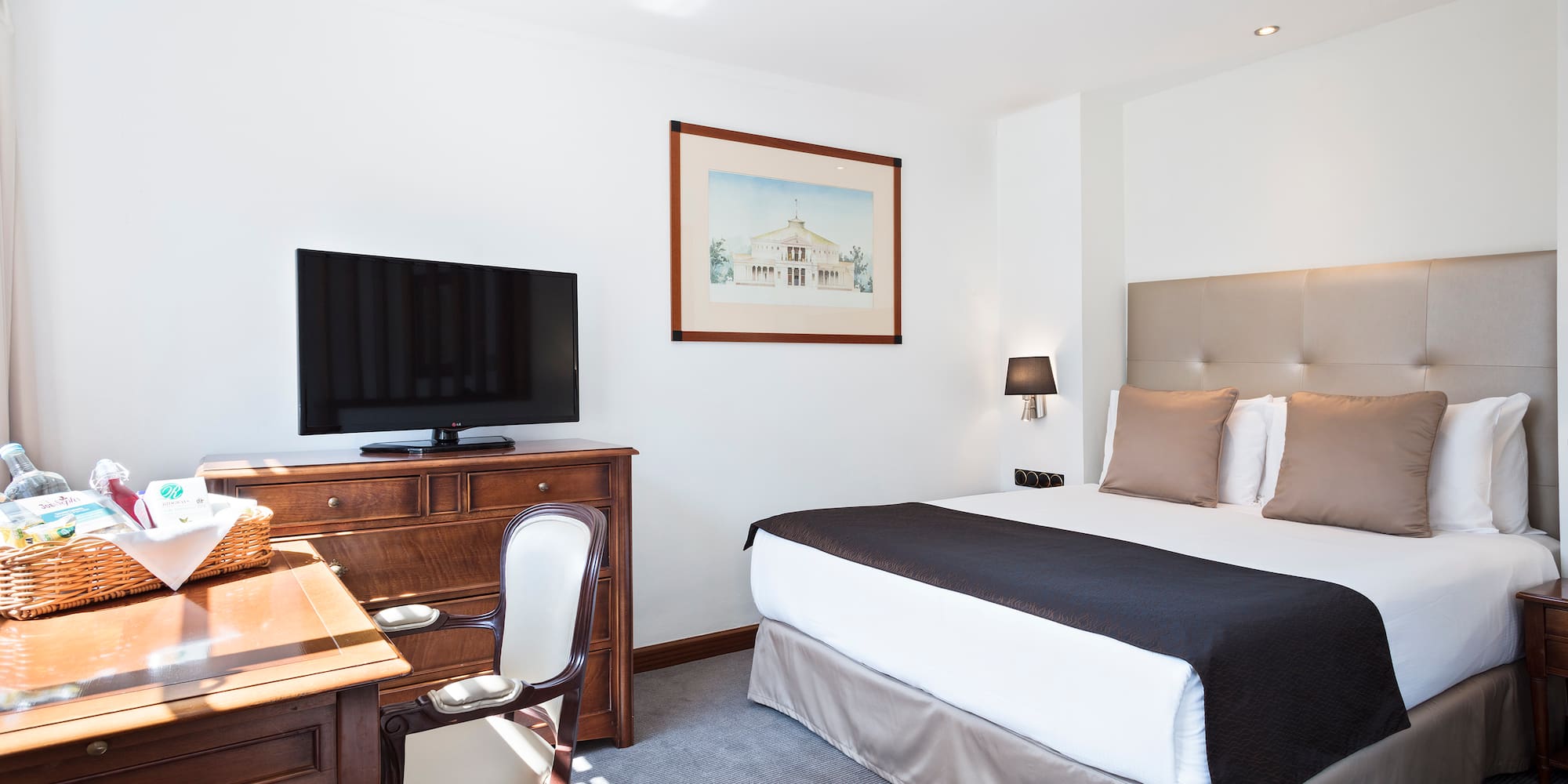 a bedroom with a bed and a desk