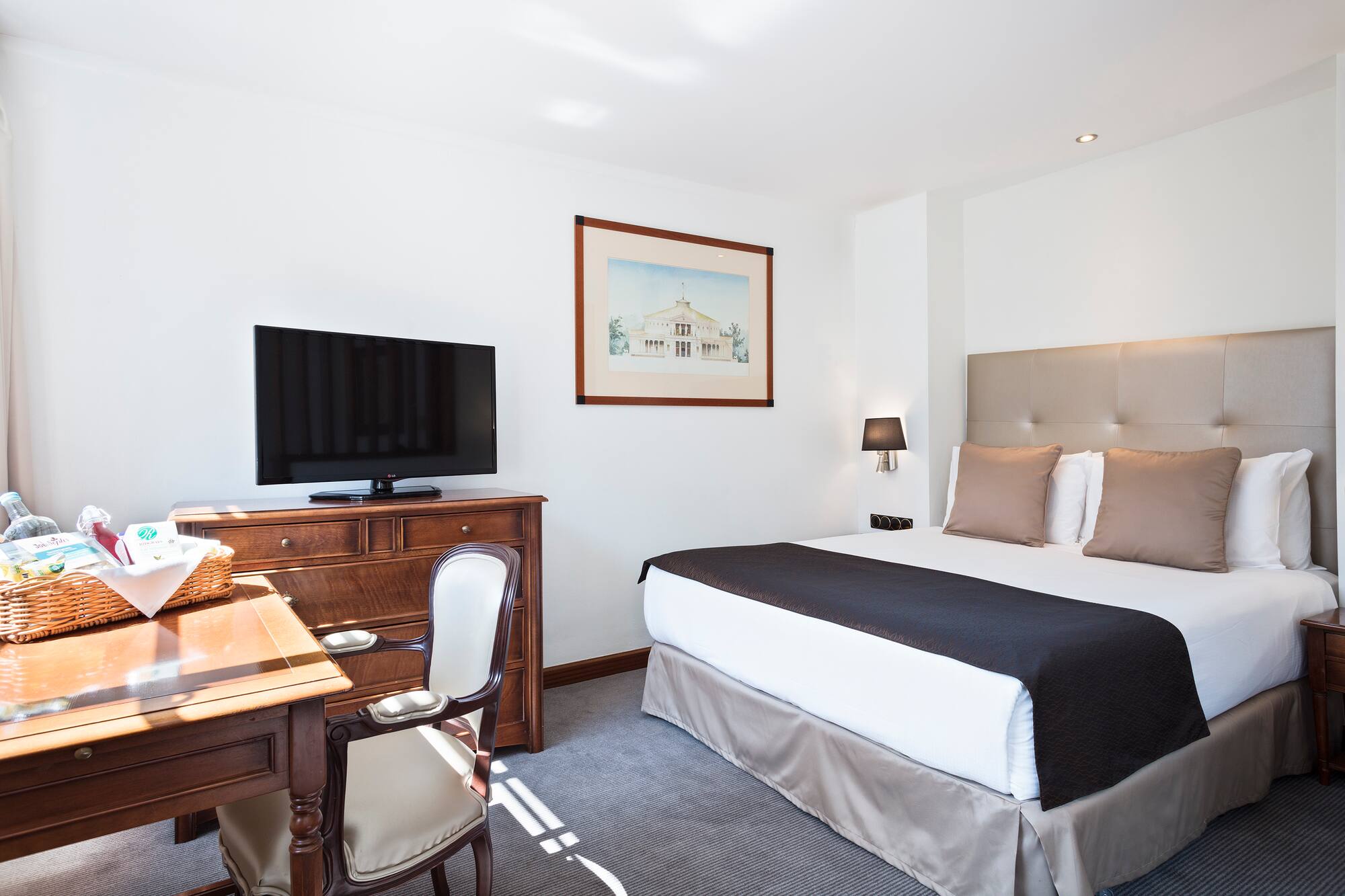 a bedroom with a bed and a desk