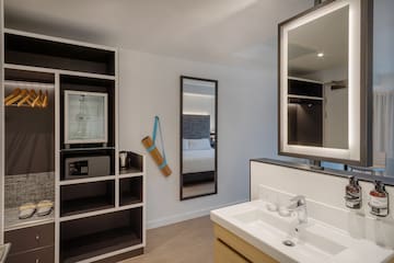 a bathroom with a mirror and shelves