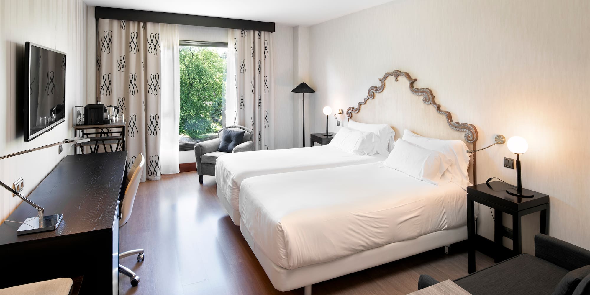 a room with two beds and a desk