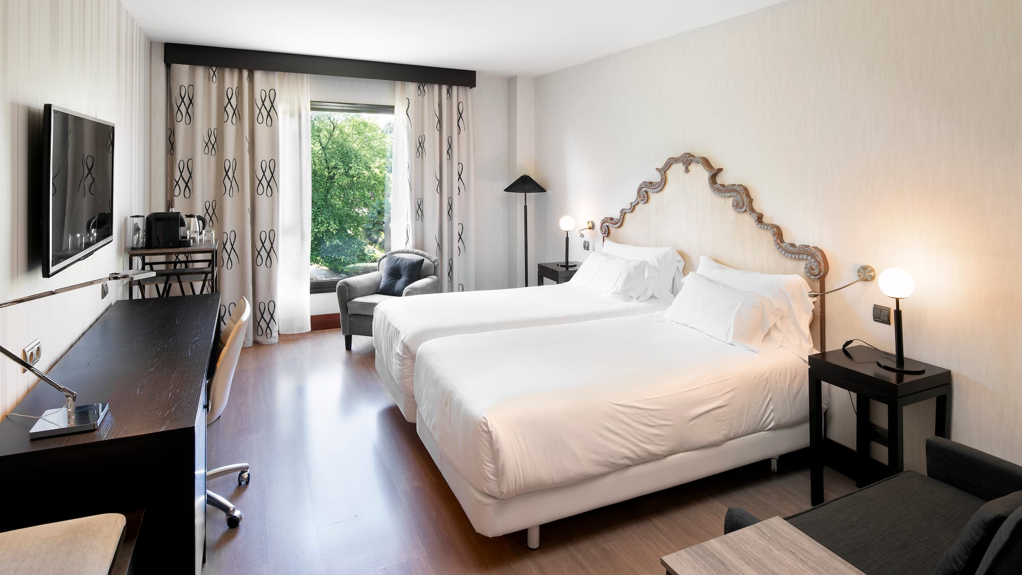 a room with two beds and a desk