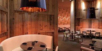 a room with a round table and chairs