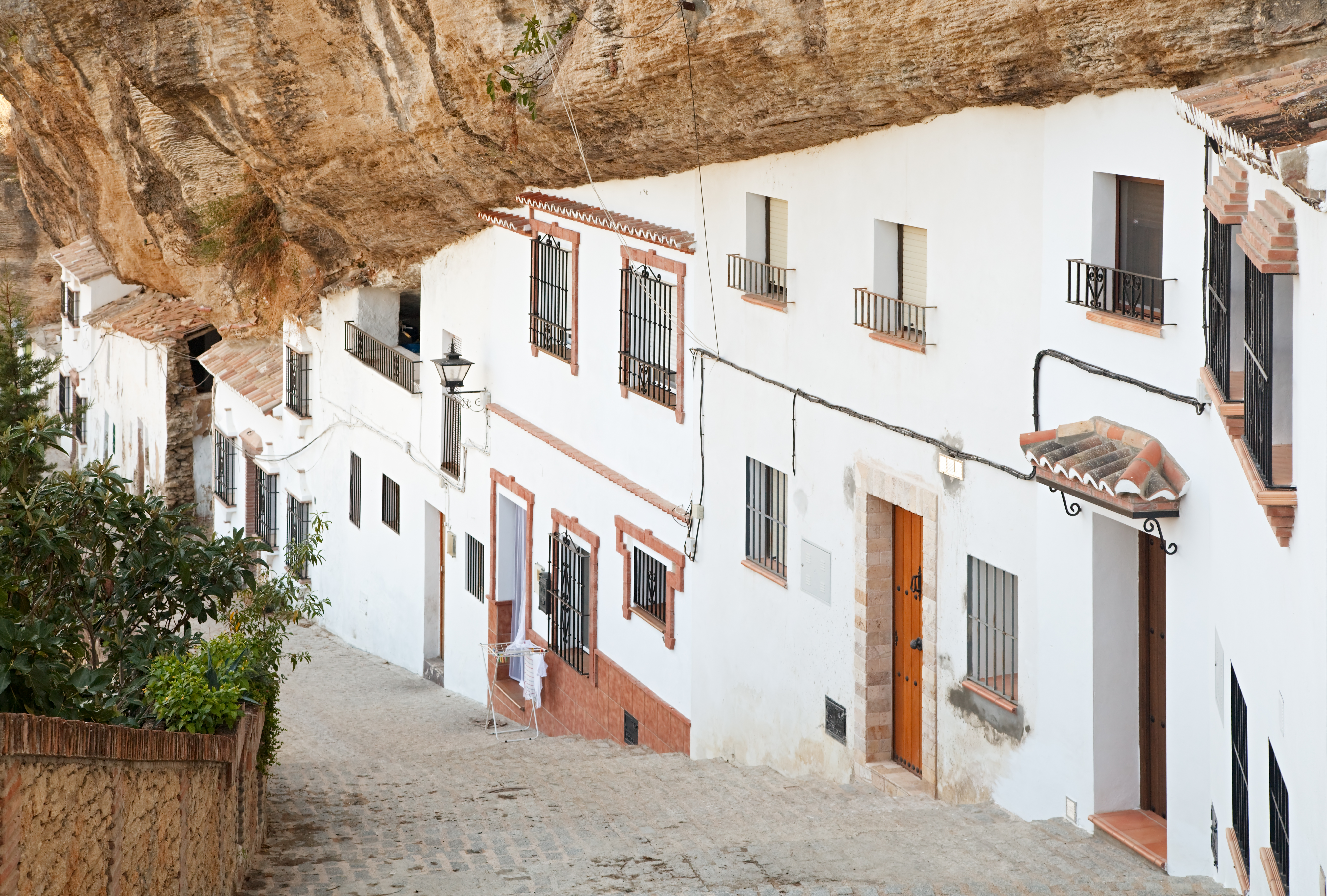 Whitewashed cave houses built into rock in Setenil de las Bodegas, Andalusia.