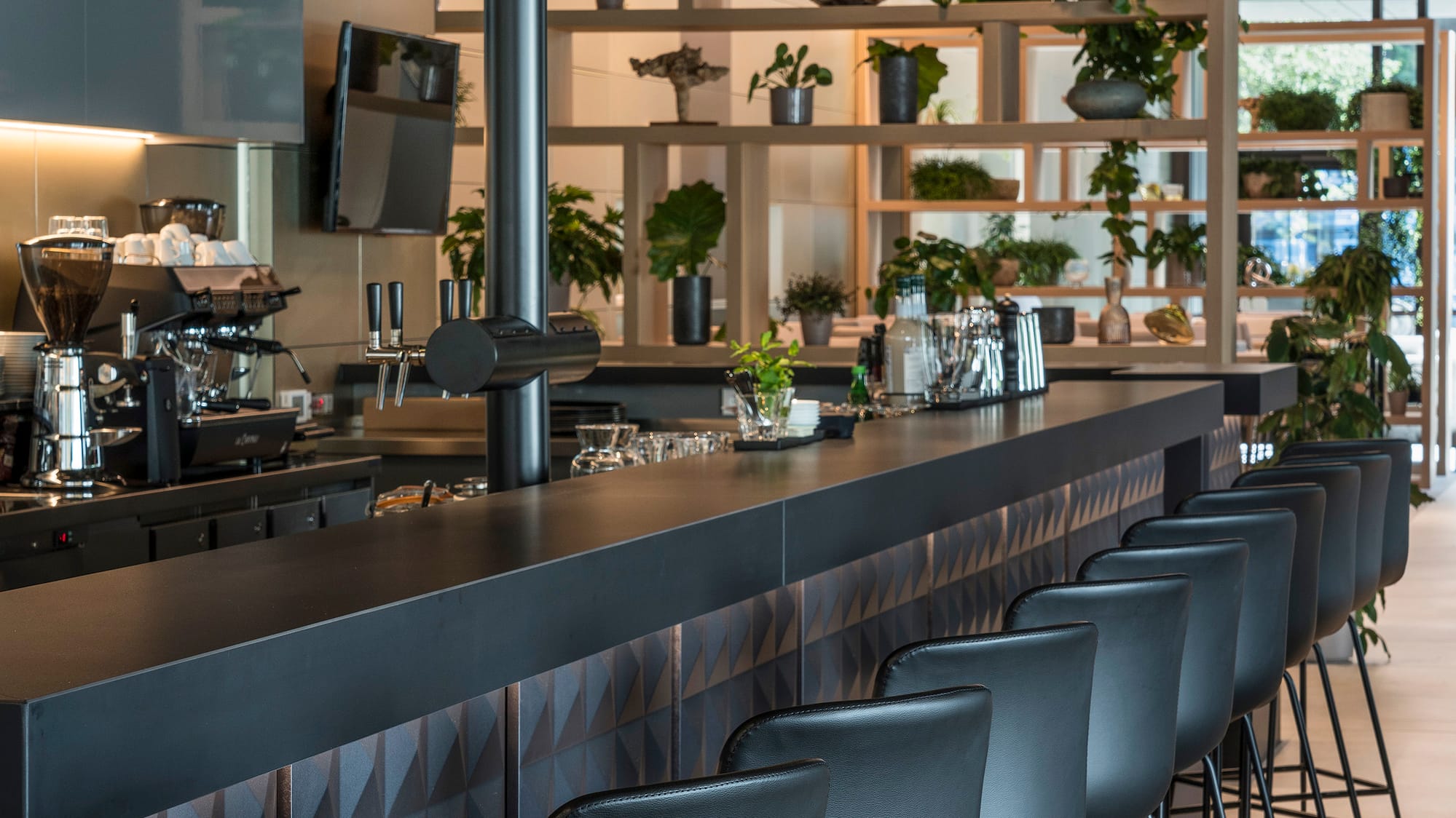 a bar with chairs in a room