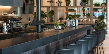 a bar with chairs in a room