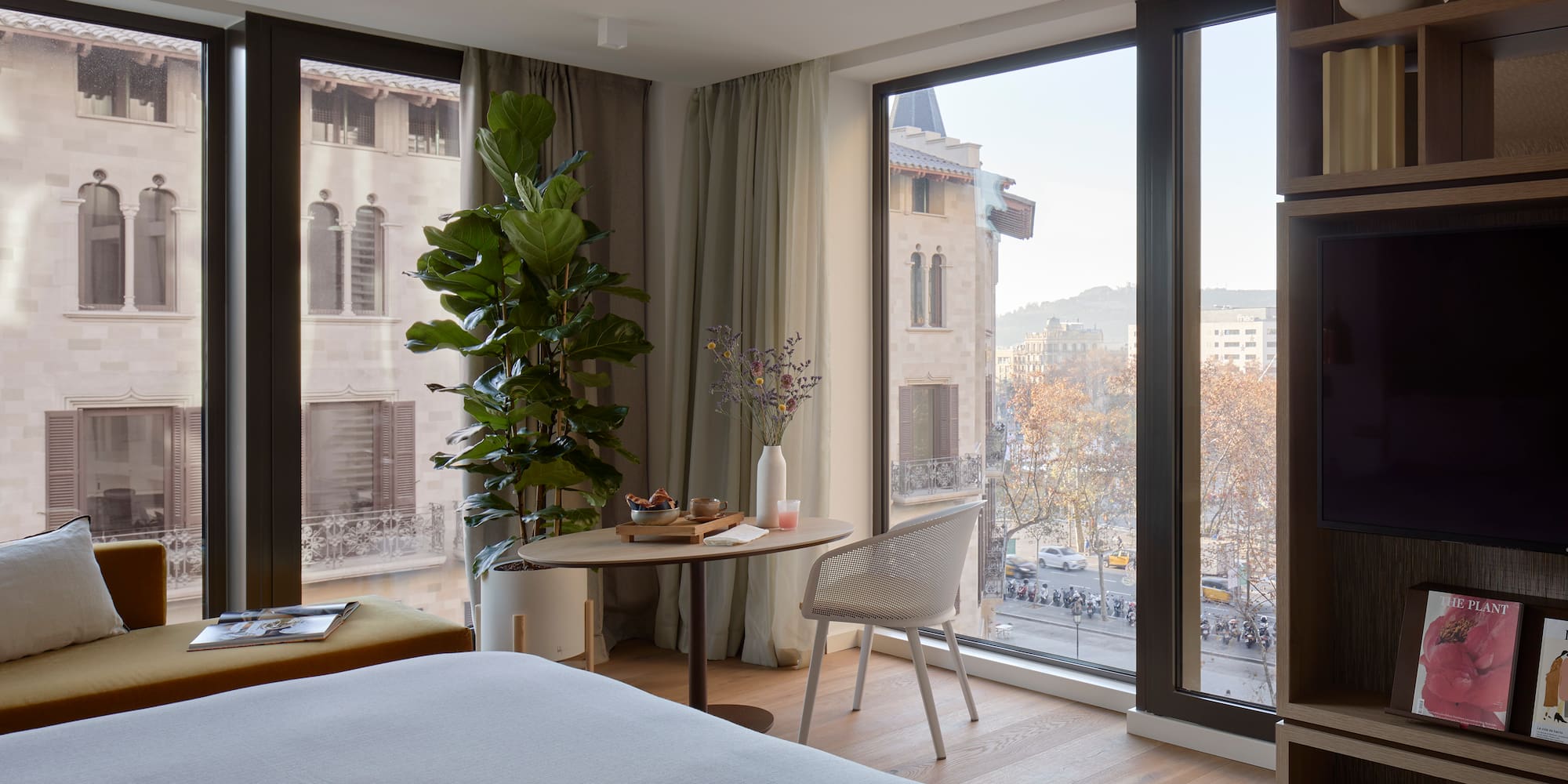 a room with a bed and a table and chairs