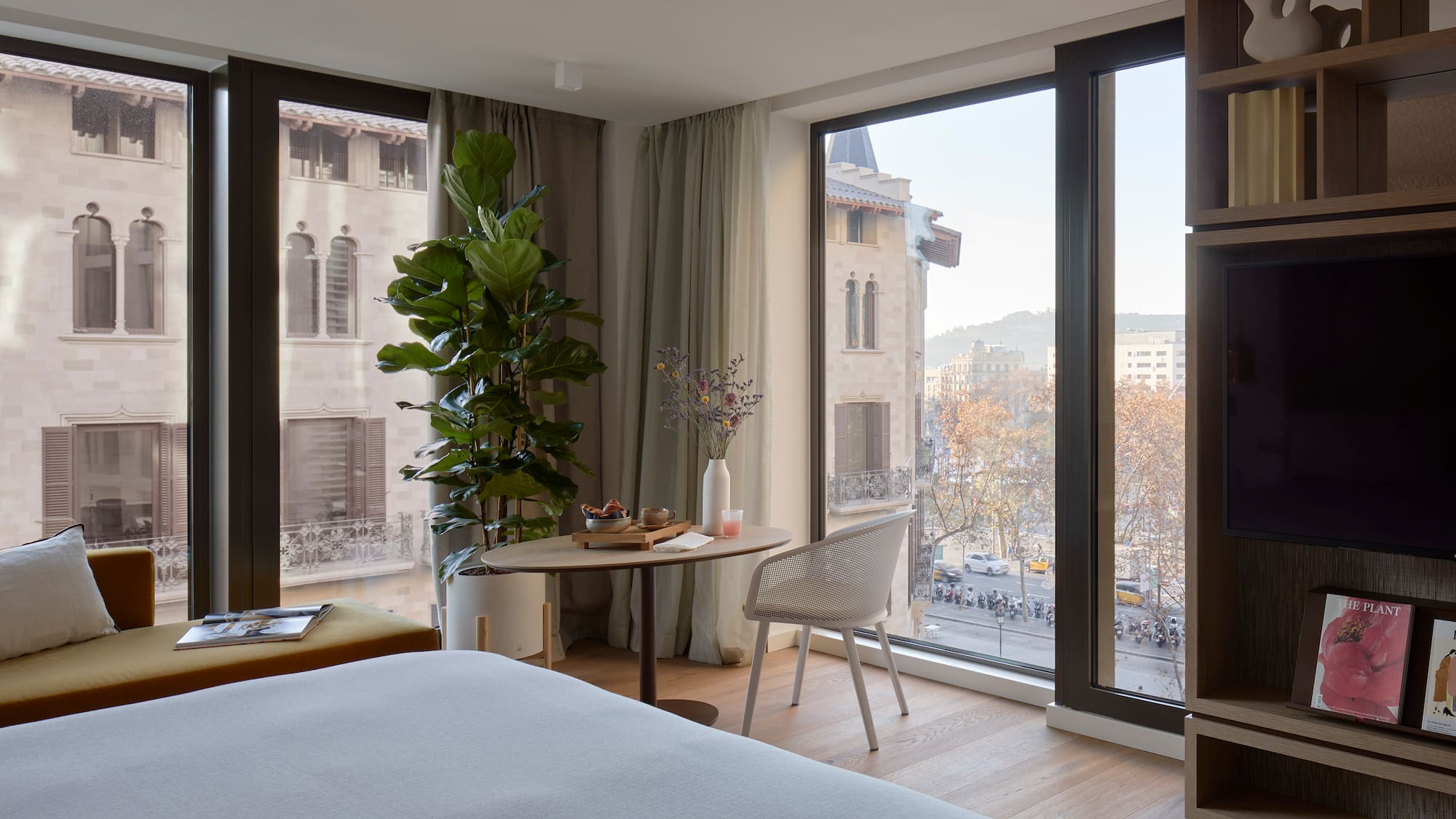 a room with a bed and a table and chairs