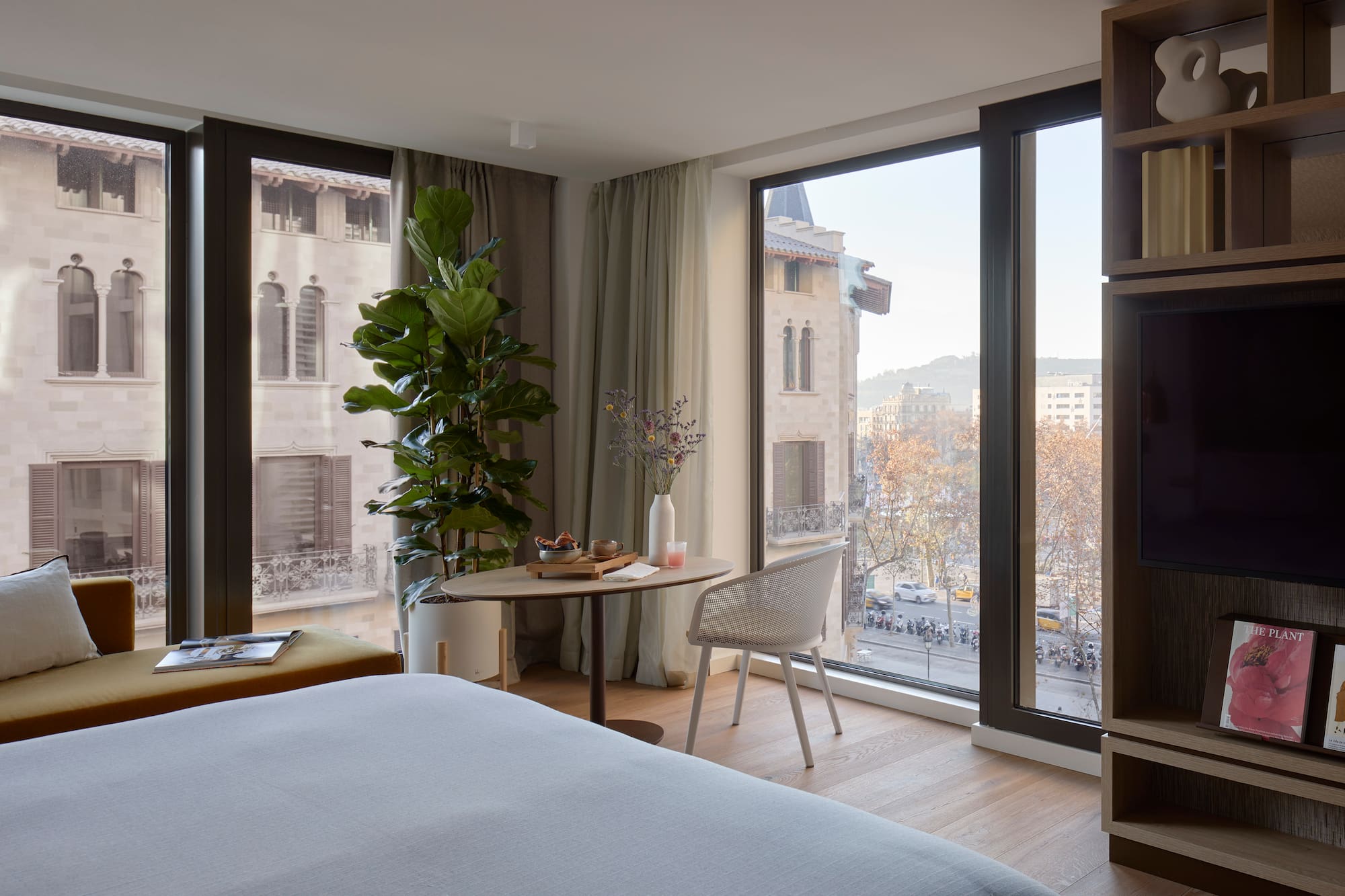 a room with a bed and a table and chairs