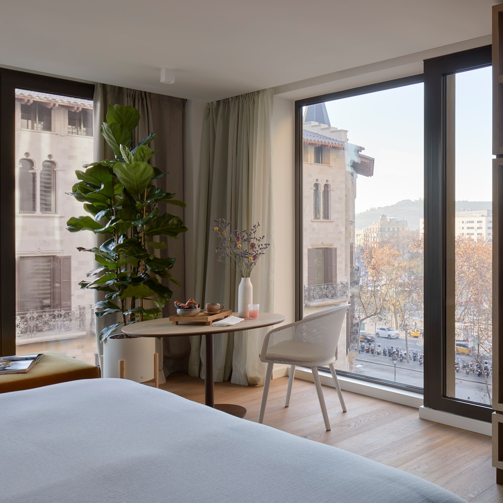 a room with a bed and a table and chairs