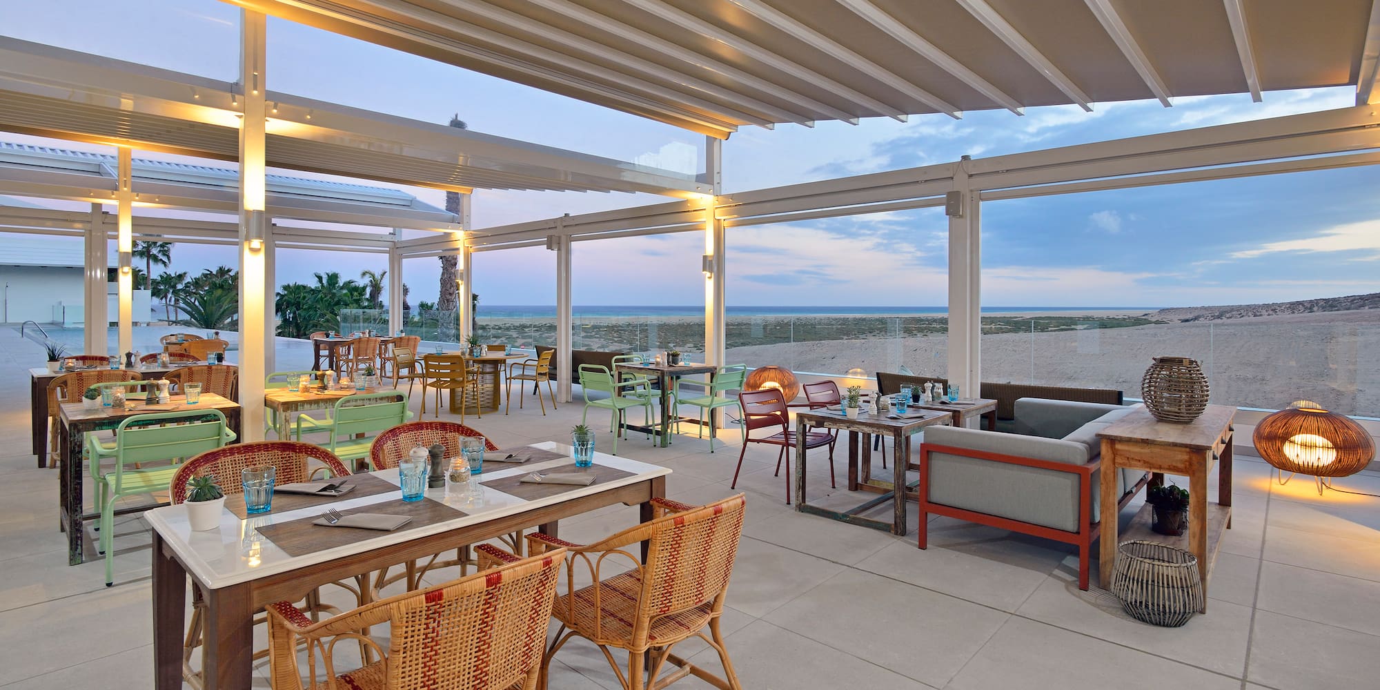 a restaurant with tables and chairs on a beach