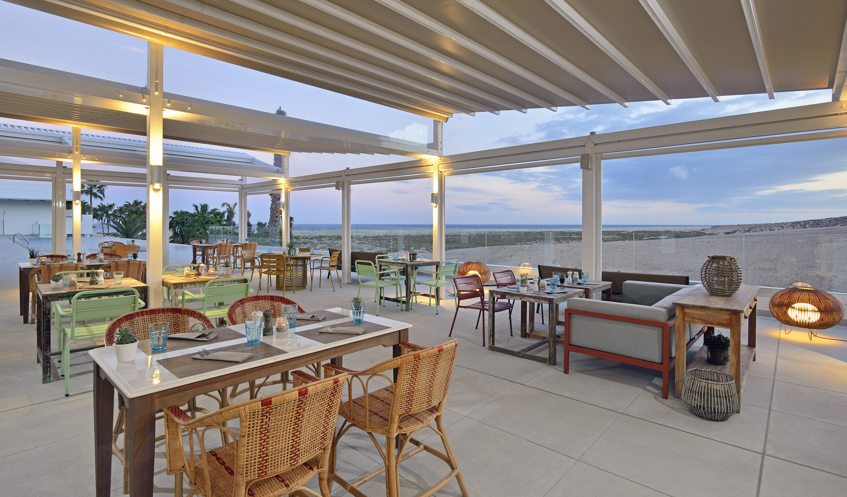 a restaurant with tables and chairs on a beach