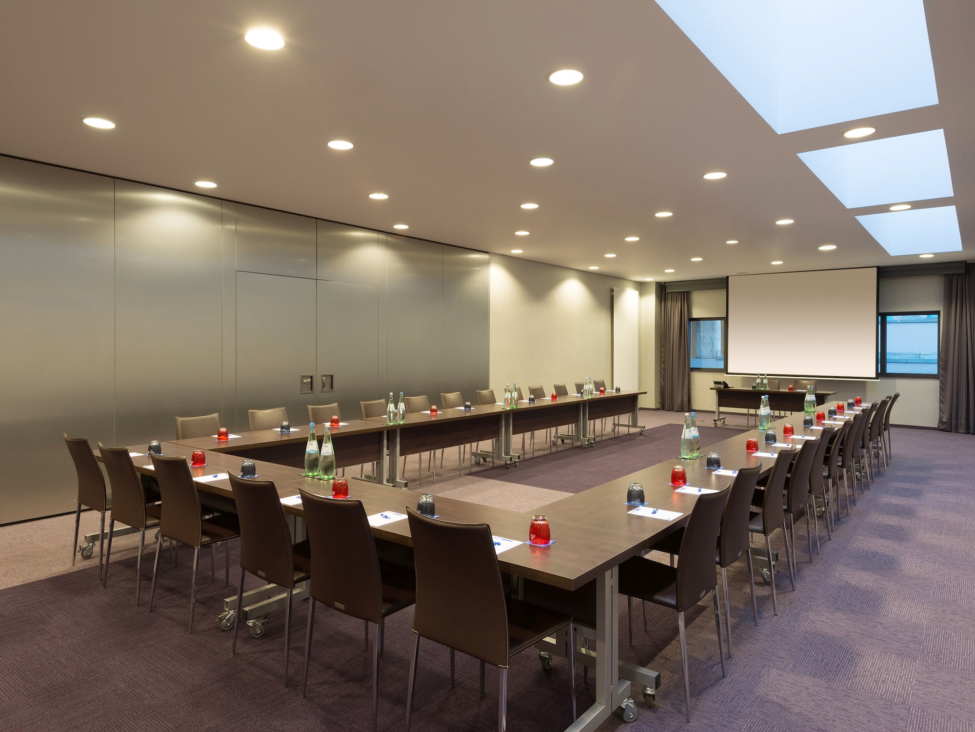a room with long tables and chairs