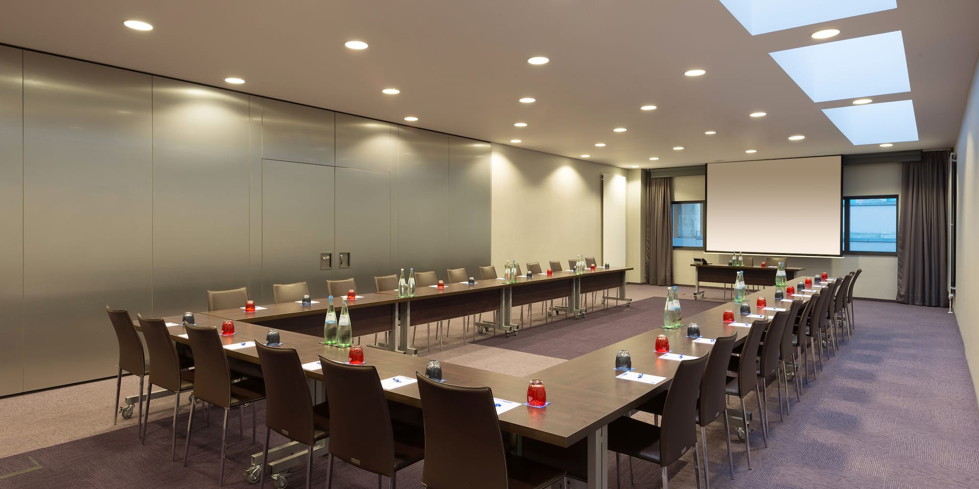 a room with long tables and chairs