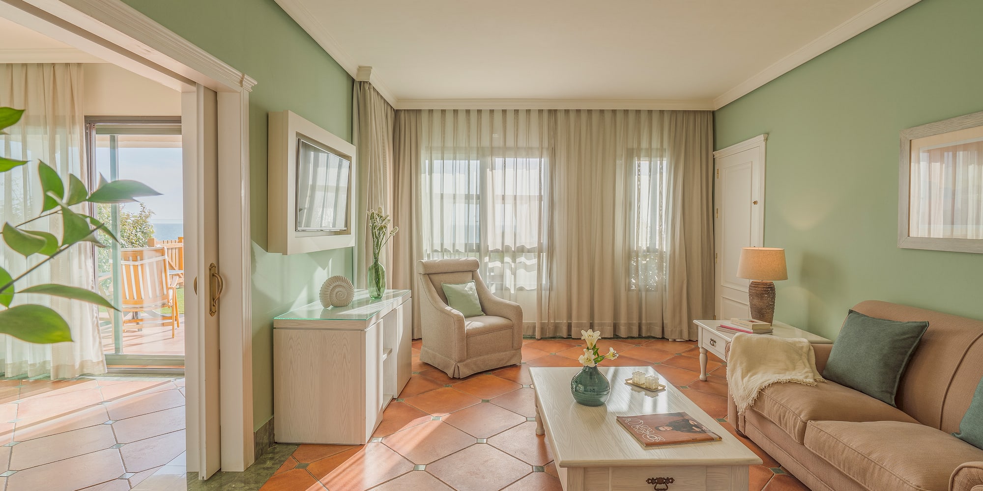 a living room with a table and chairs