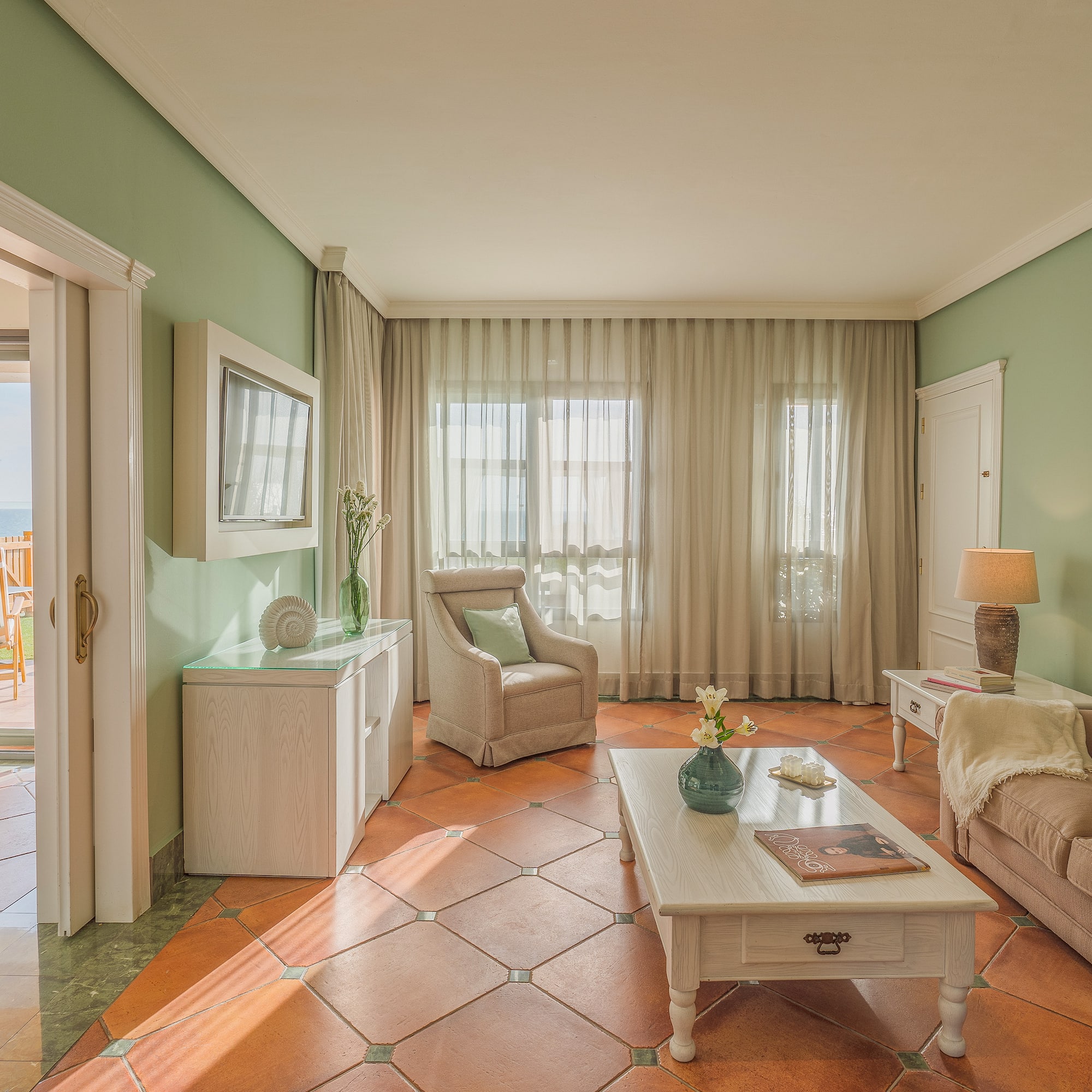 a living room with a table and chairs