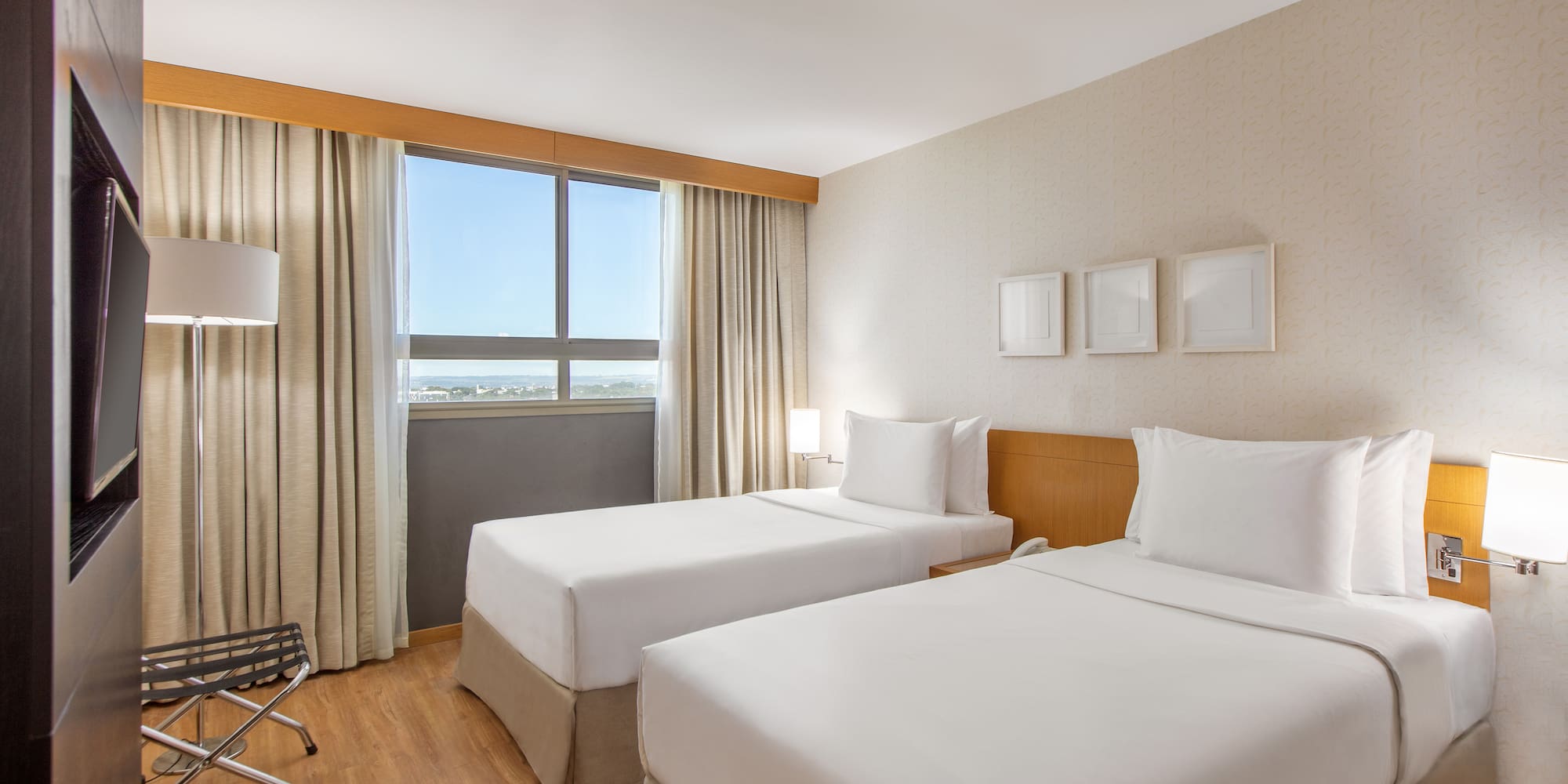 a room with two beds and a wood floor