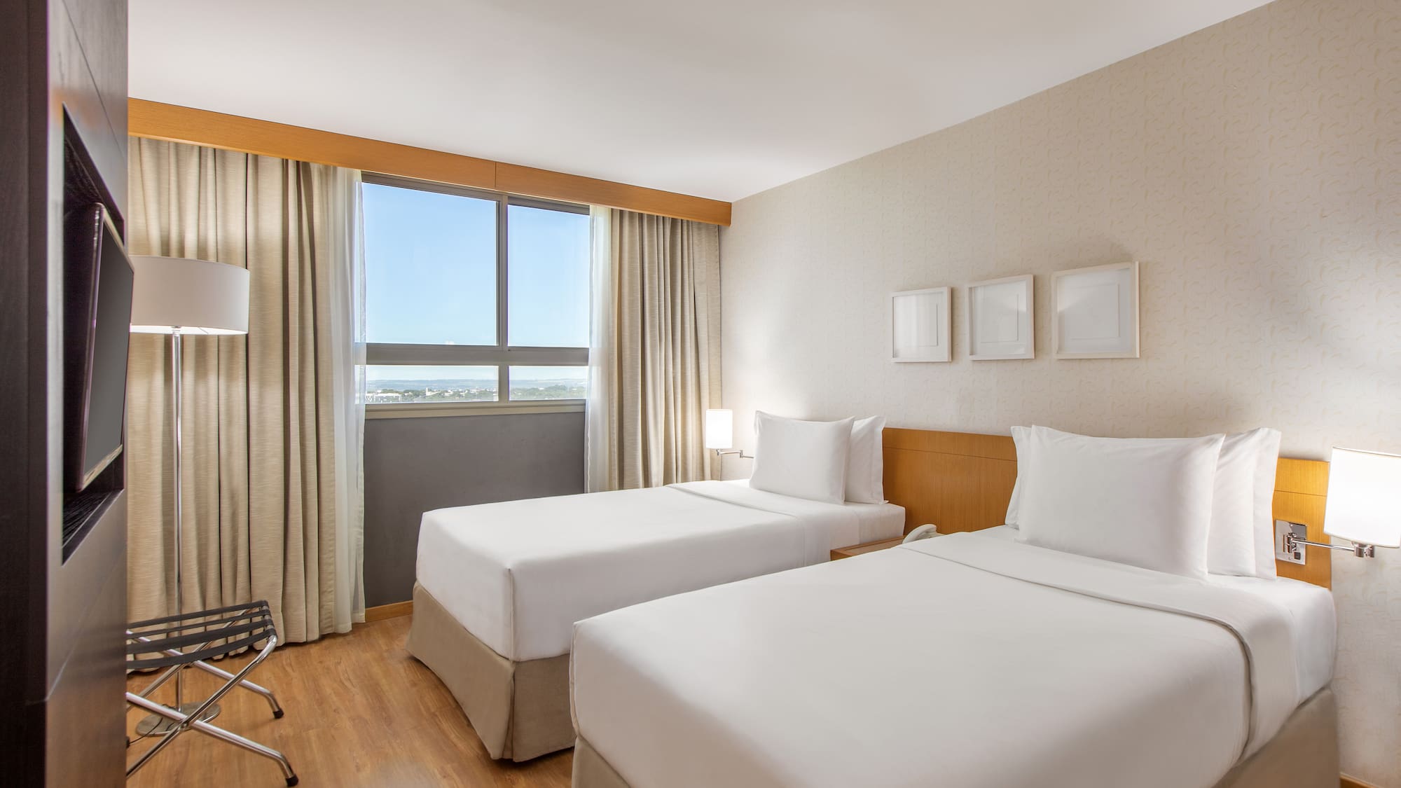 a room with two beds and a wood floor