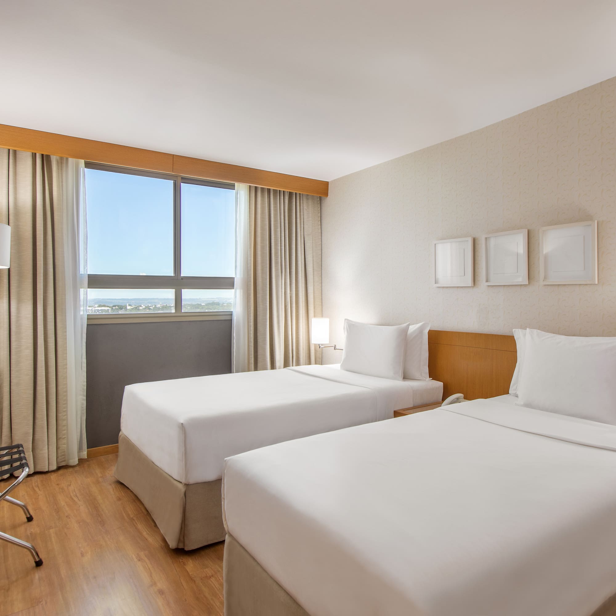 a room with two beds and a wood floor