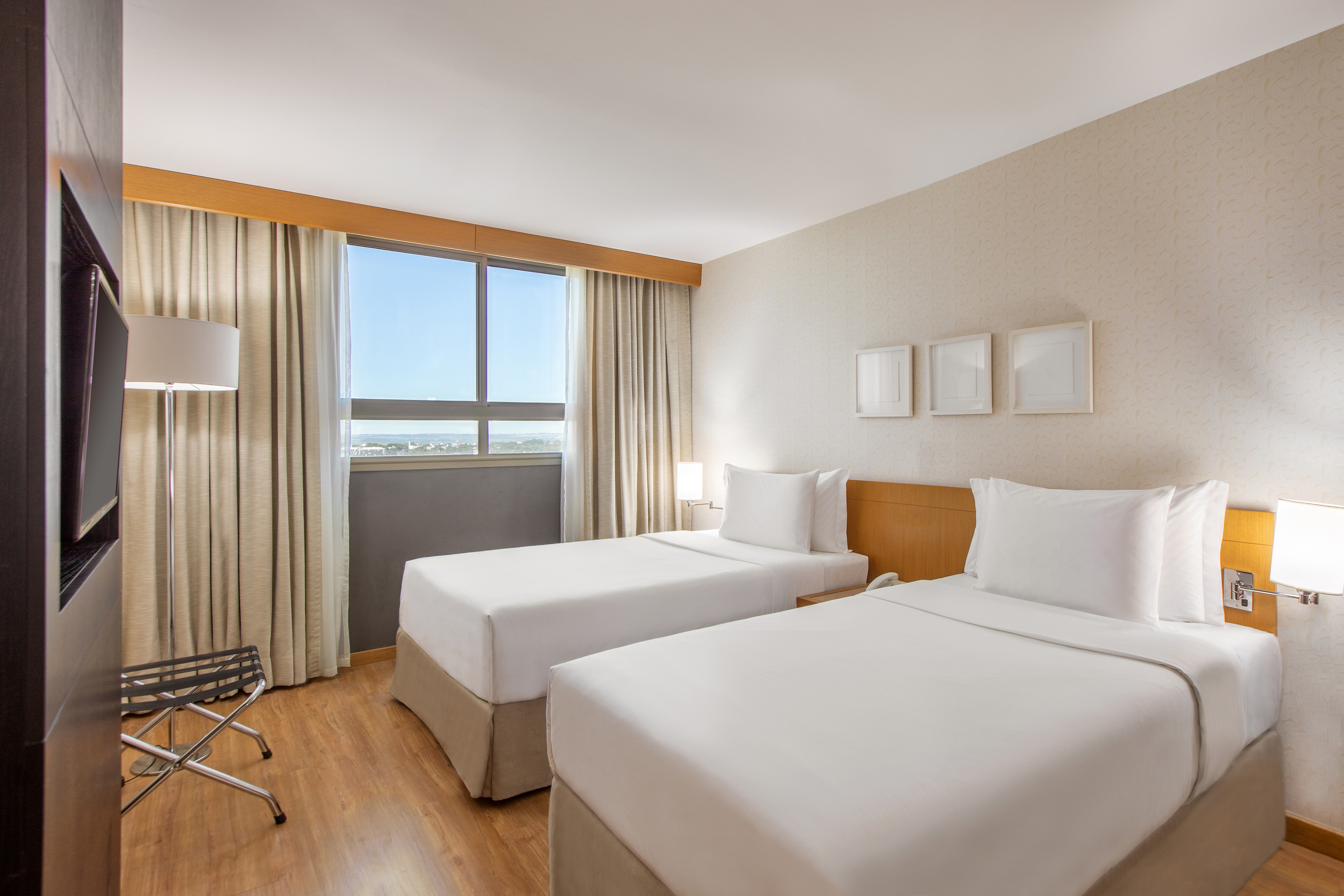 a room with two beds and a wood floor