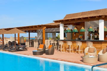 a pool with chairs and tables