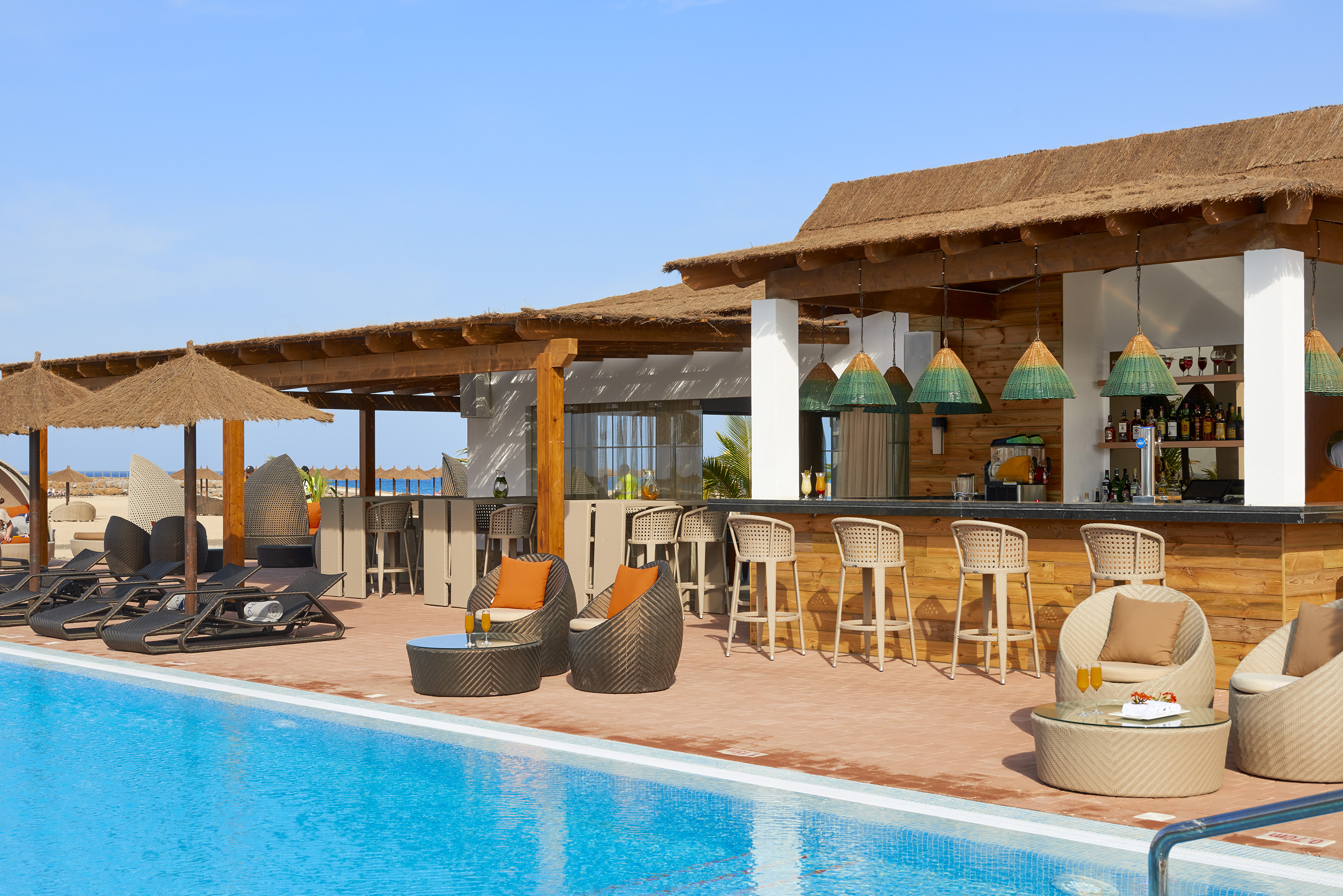 a pool with chairs and tables
