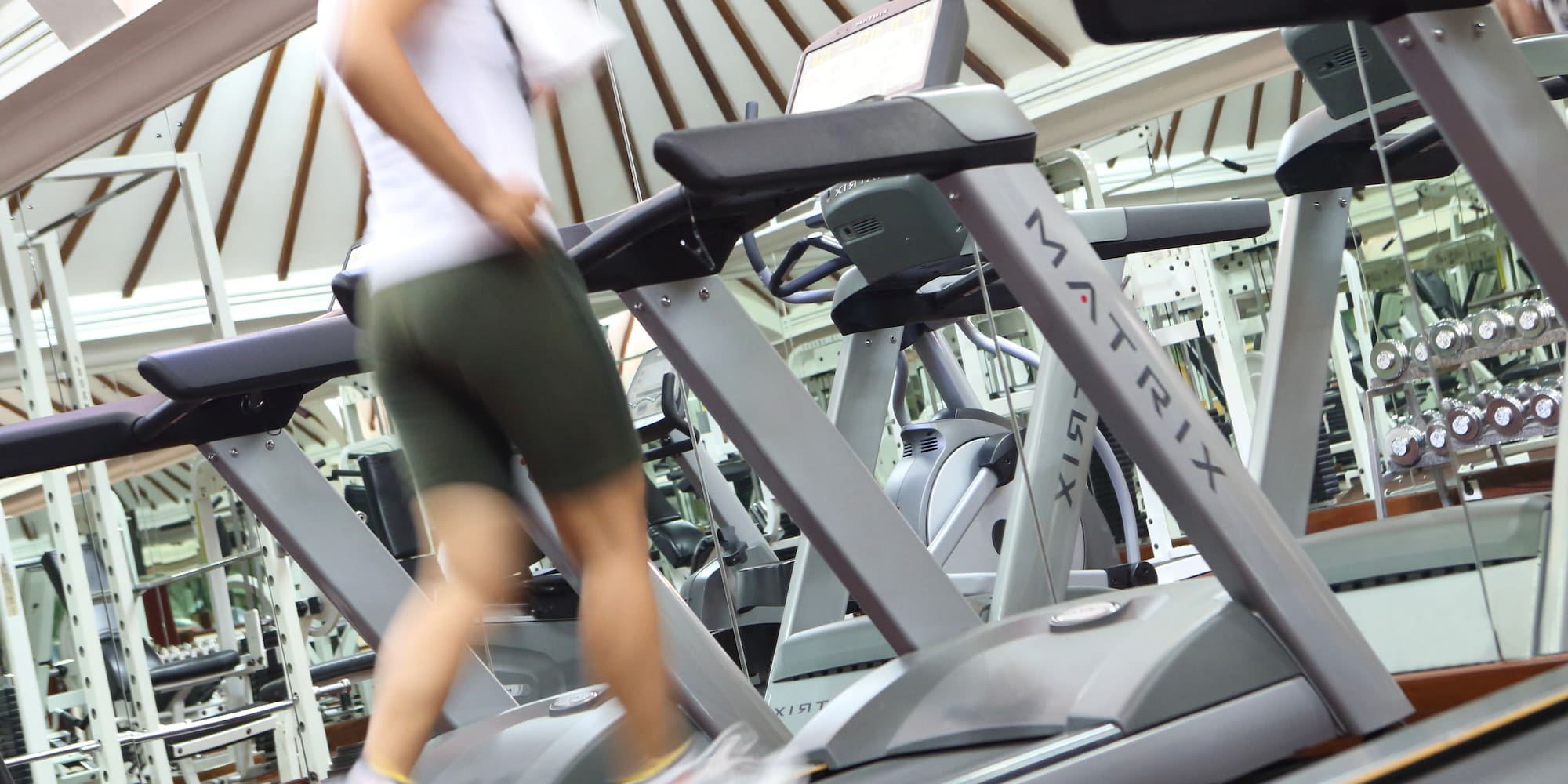 a woman walking on a treadmill