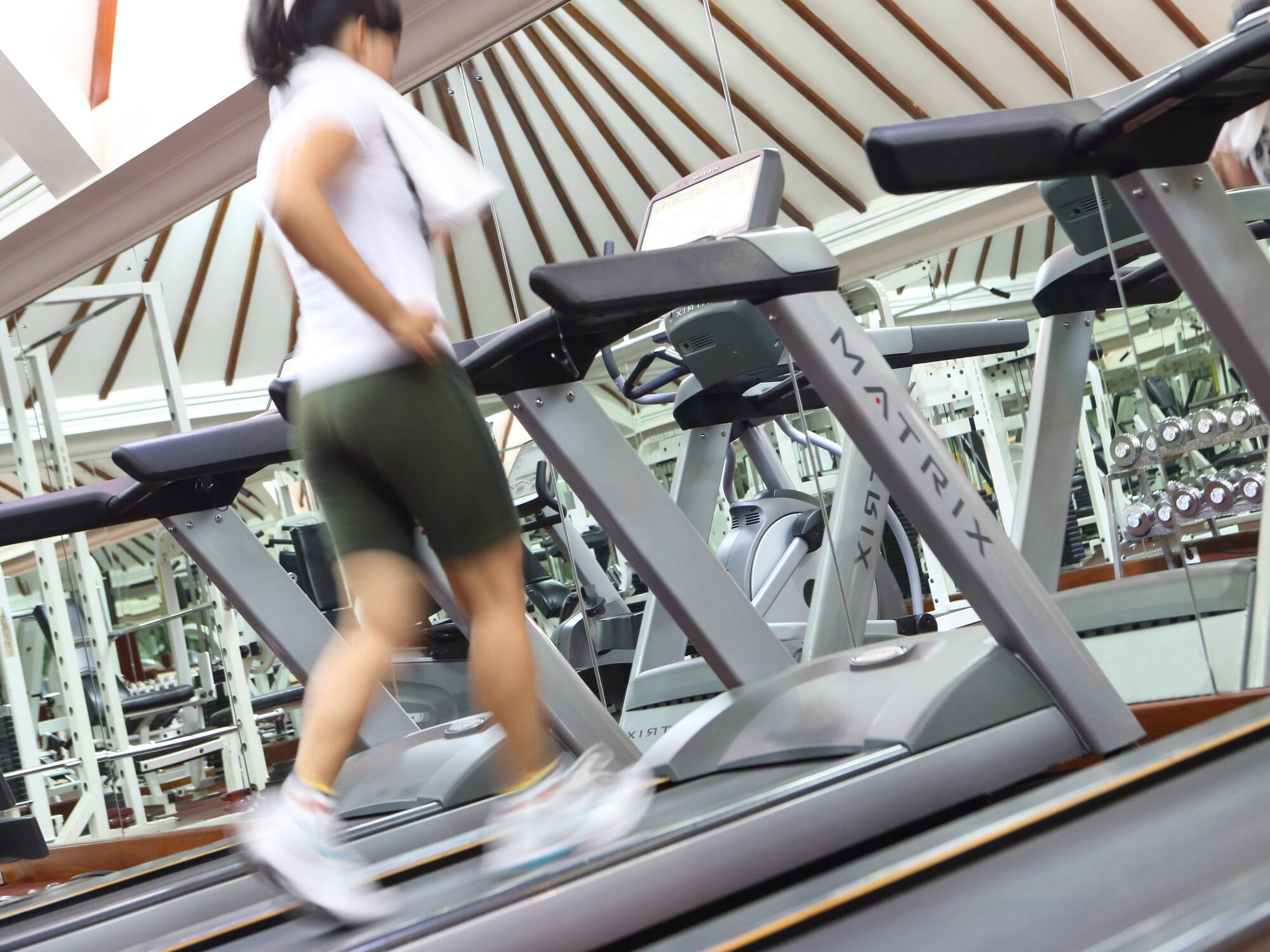 a woman walking on a treadmill