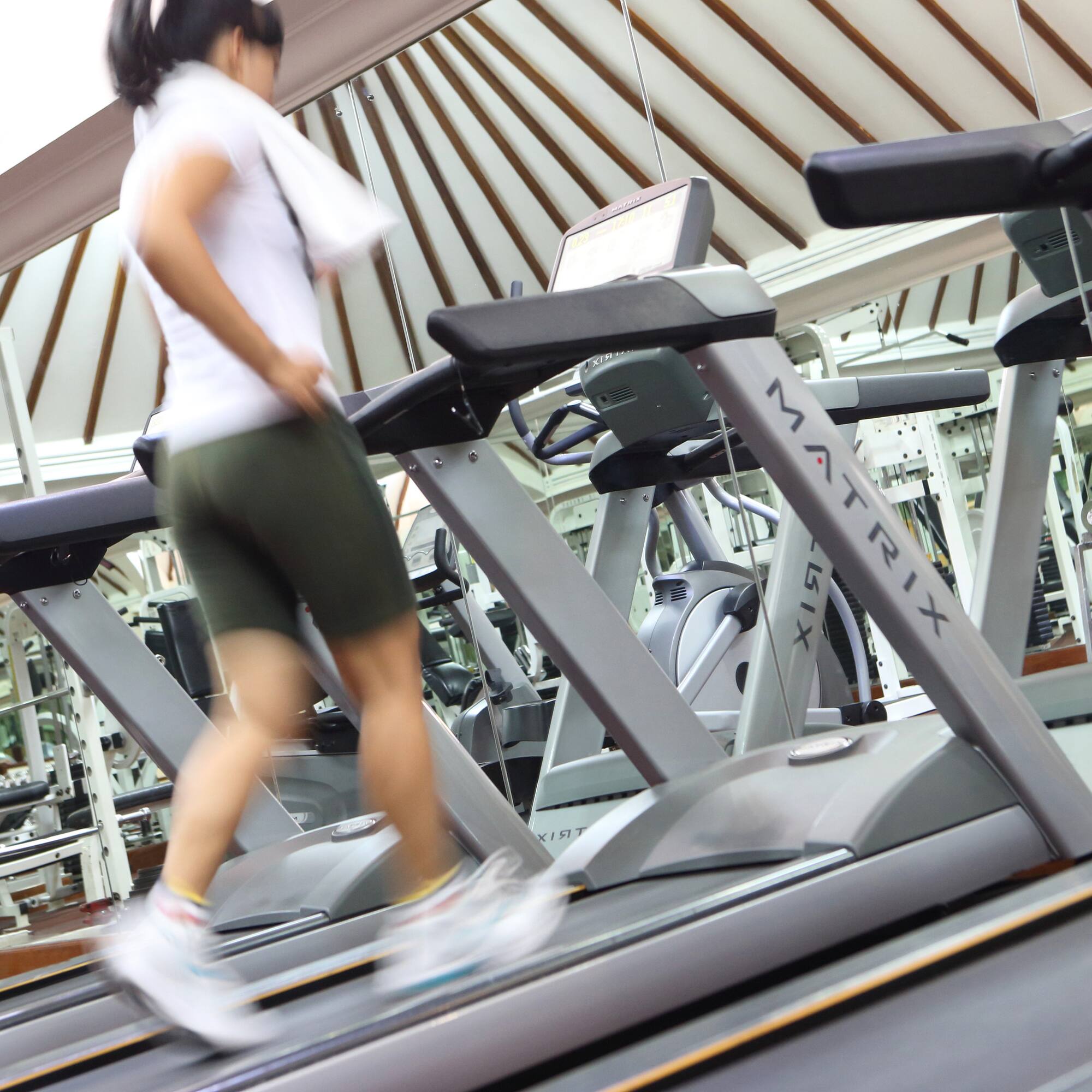 a woman walking on a treadmill